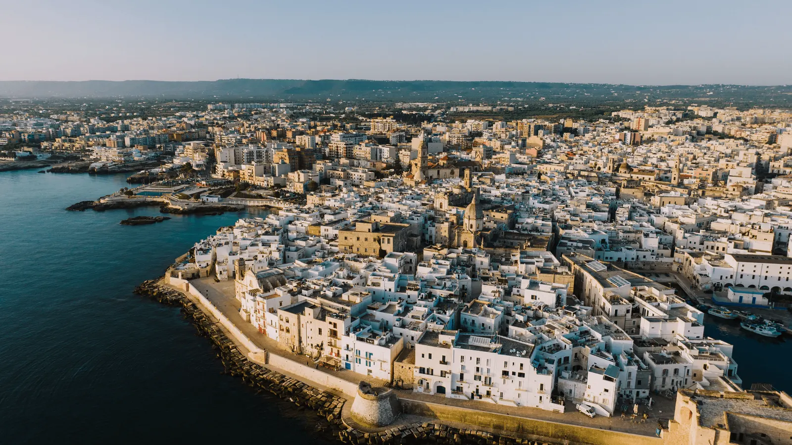 Aerial view of a whitewashed coastal town on the Puglia coastline