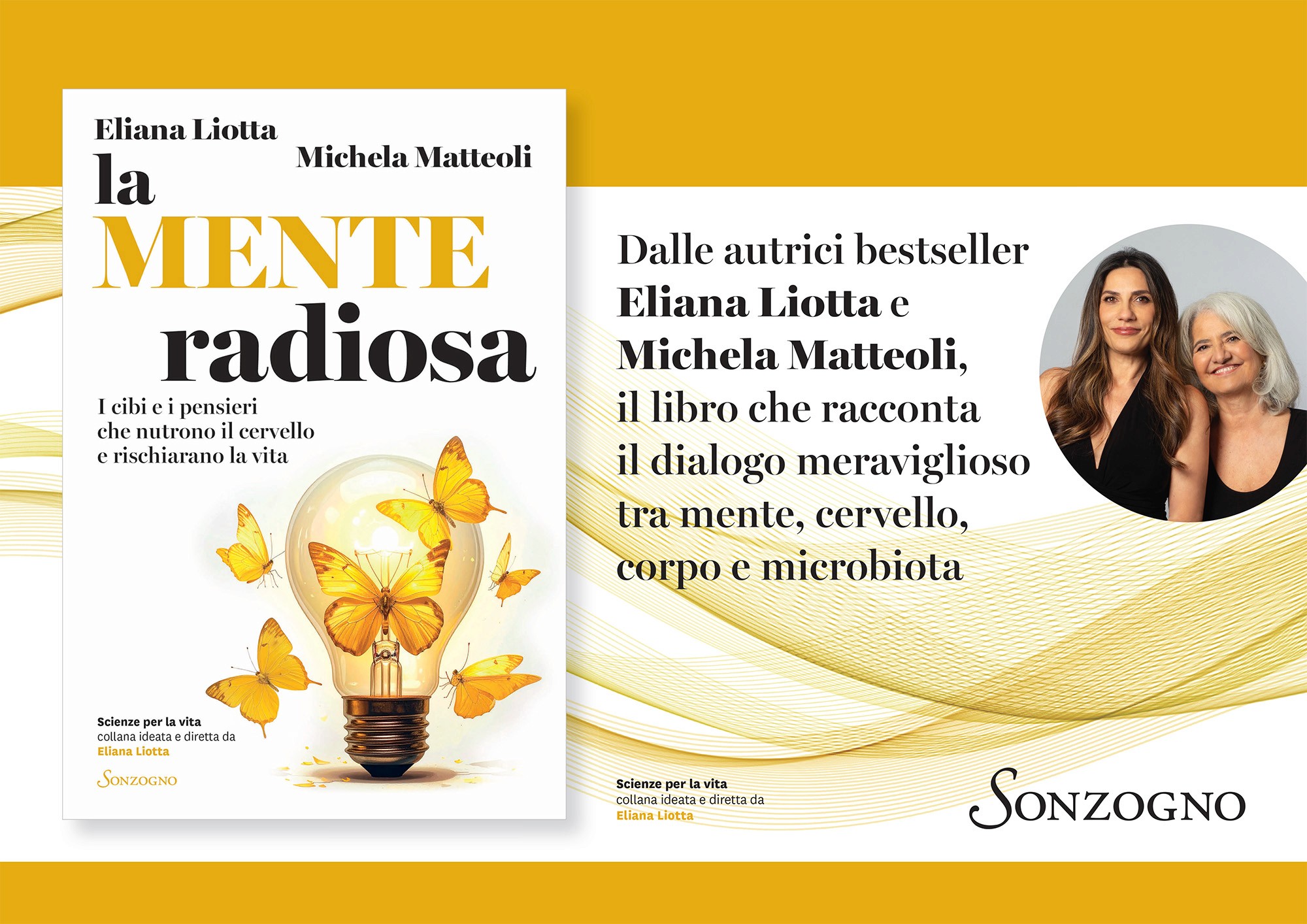 A young person with curly hair smiles at the camera while sitting in front of a laptop against a dark background.