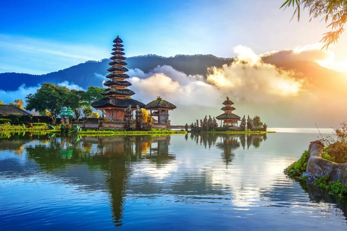 Serene Balinese lake temple reflection.