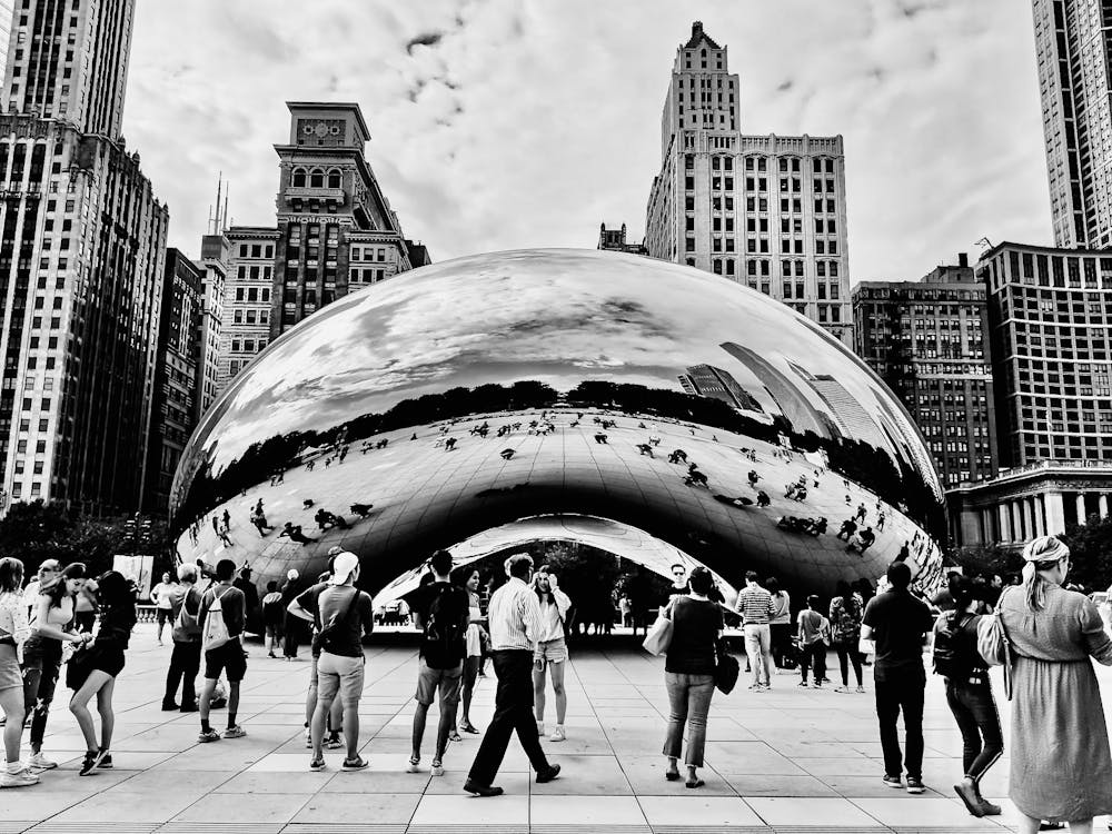 A young person with long, wavy hair sits in front of a plain background, looking directly at the camera.