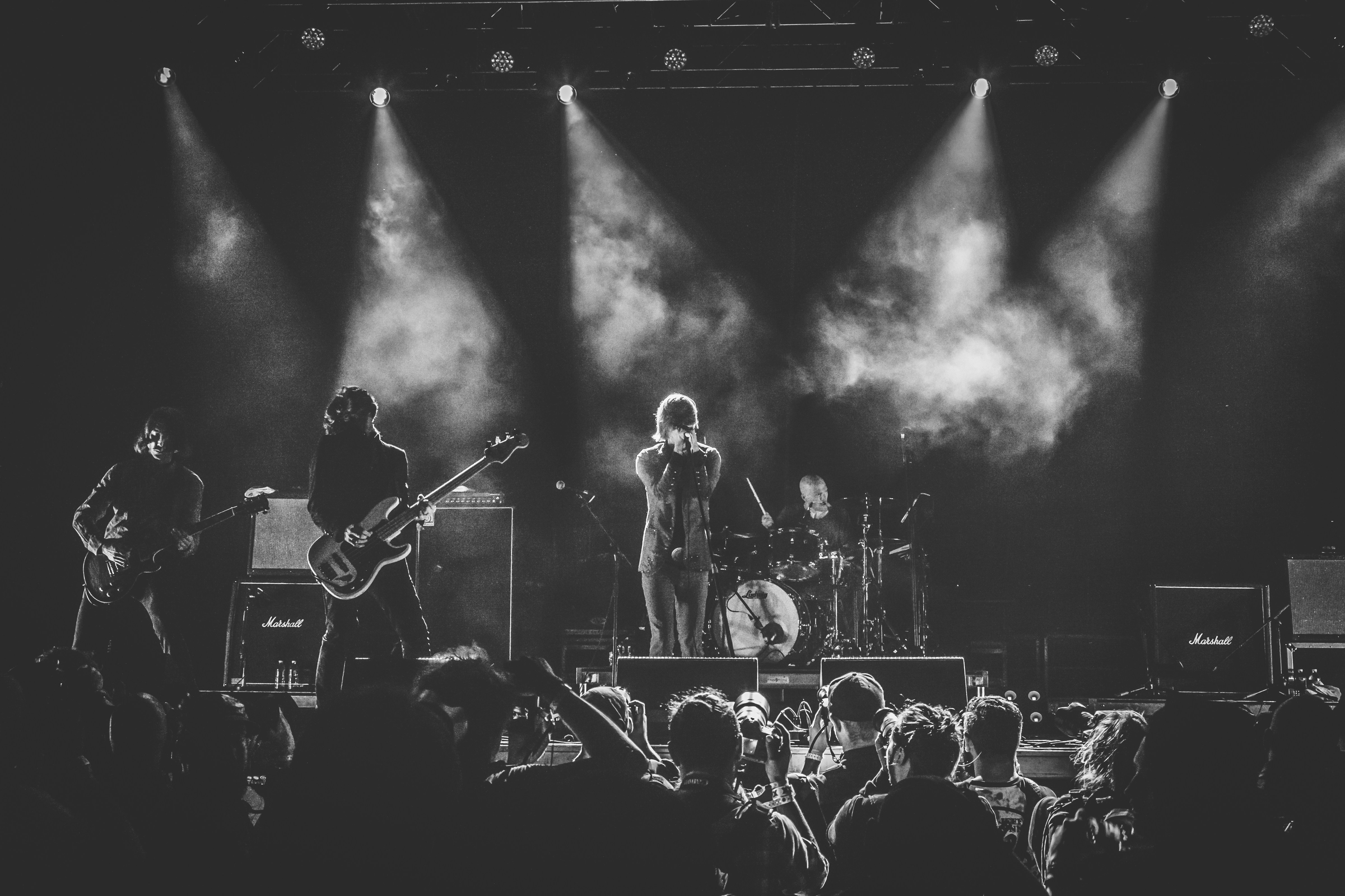 grayscale photo of band performing on stage
