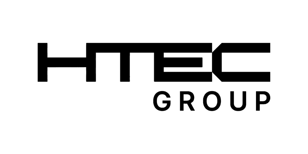 a young man wearing glasses standing in front of a mountain