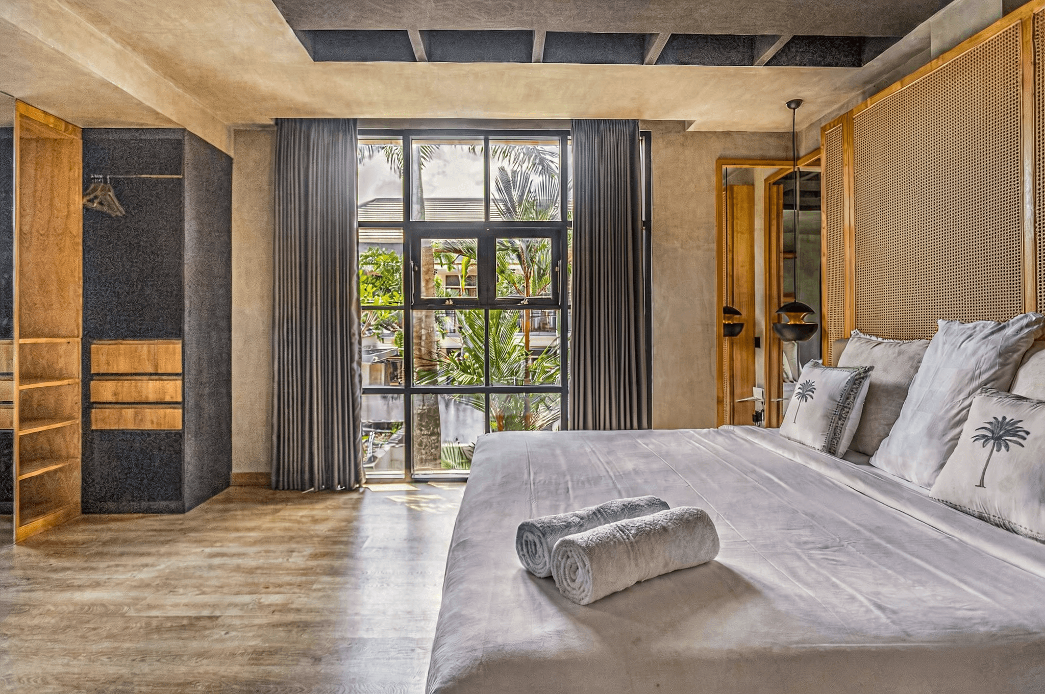 Modern bedroom with a view of tropical greenery. Specialist real estate guidance for property seekers in Canggu.
