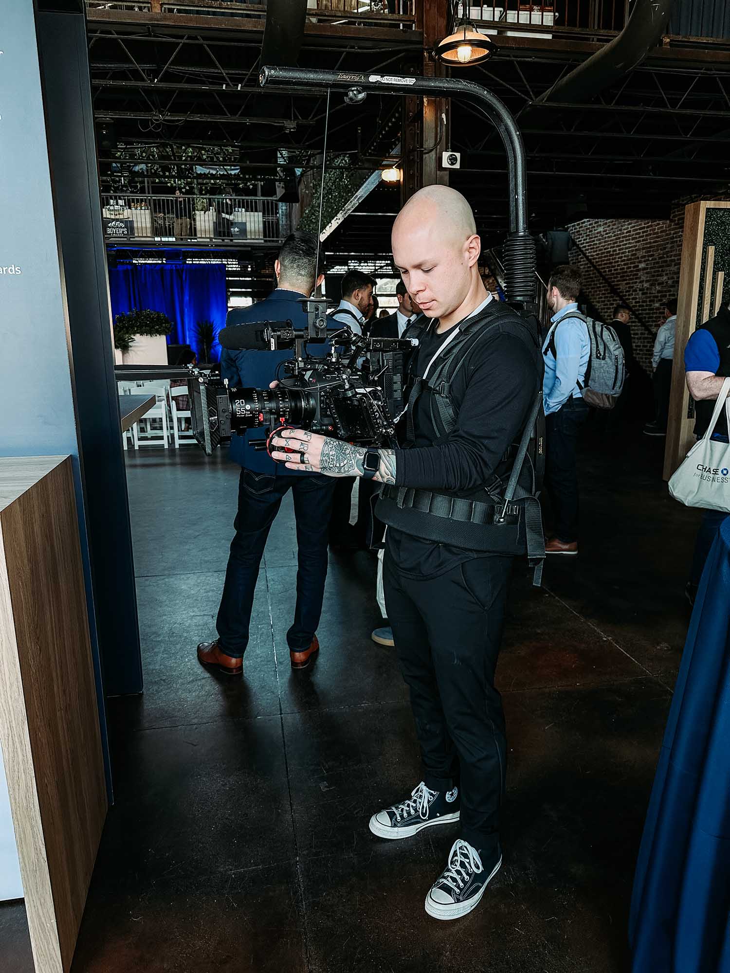 Jason Luong operating a camera at an event