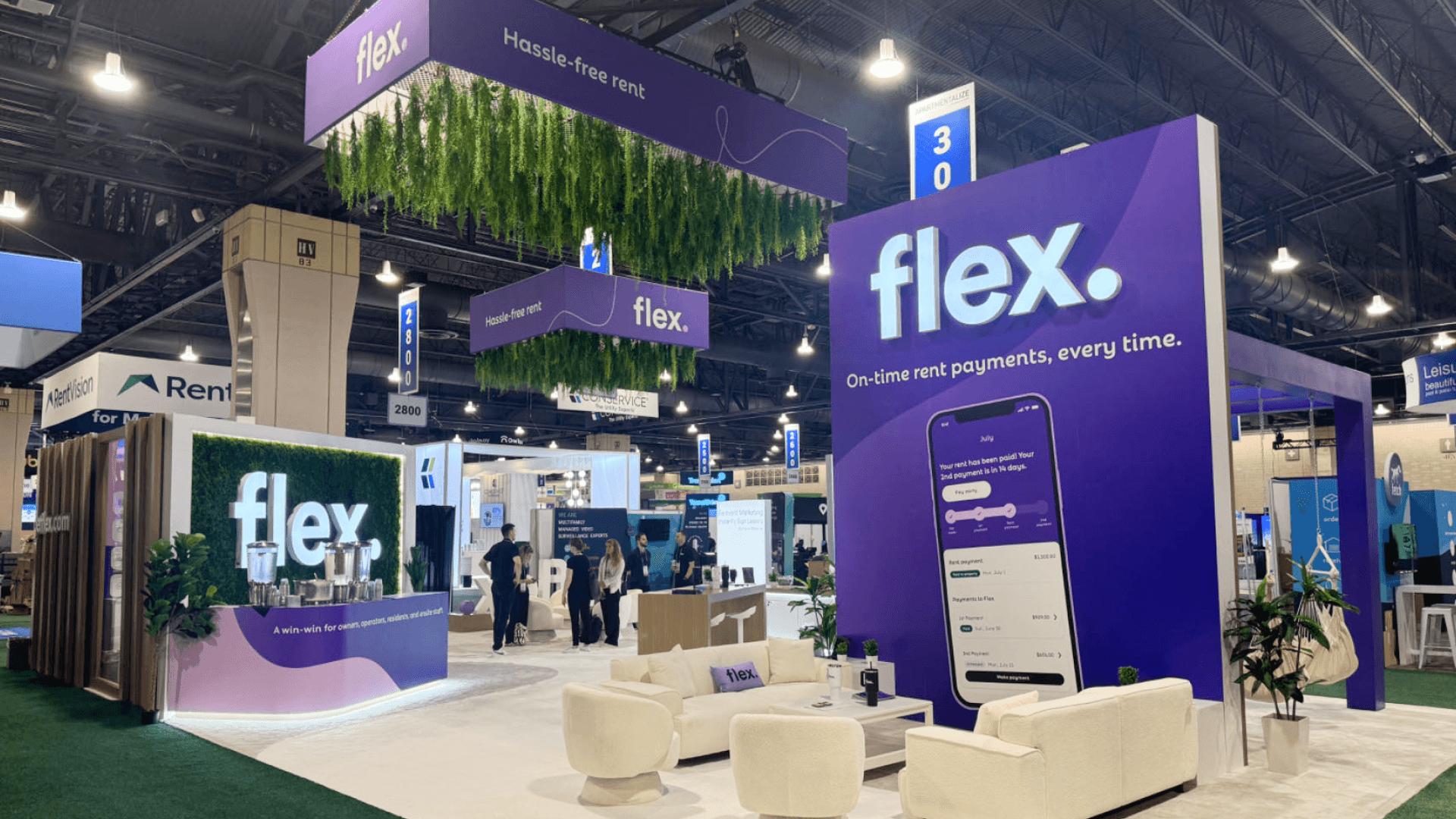 Flex NAA Apartmentalize 2024 large island trade show booth with brand storytelling wall and open entry path