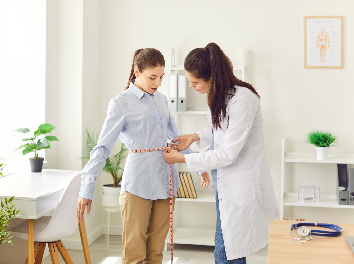 woman checking her results at the doctor to see the benefits of a vibration plate for weight loss alongside a diet plan