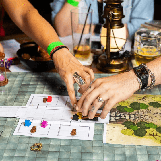 friends playing a board game focused on hands in the tavern during checkmates