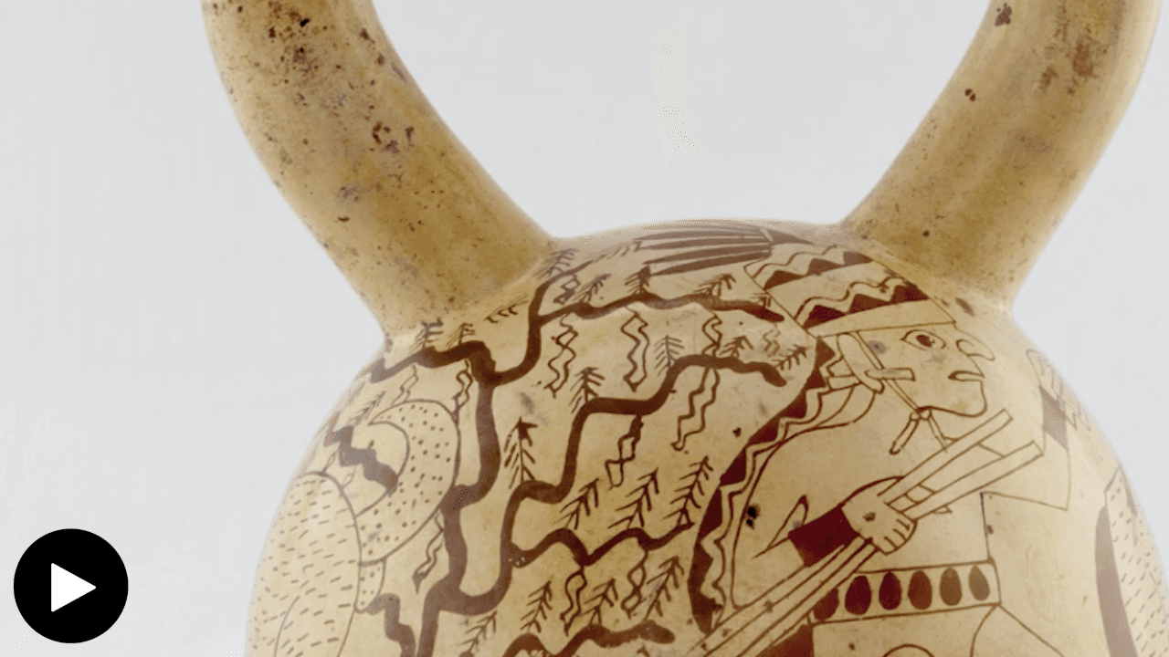 A close-up detail of a stirrup-spout Moche vessel. It features a drawing of a stylized hunter and a tree.