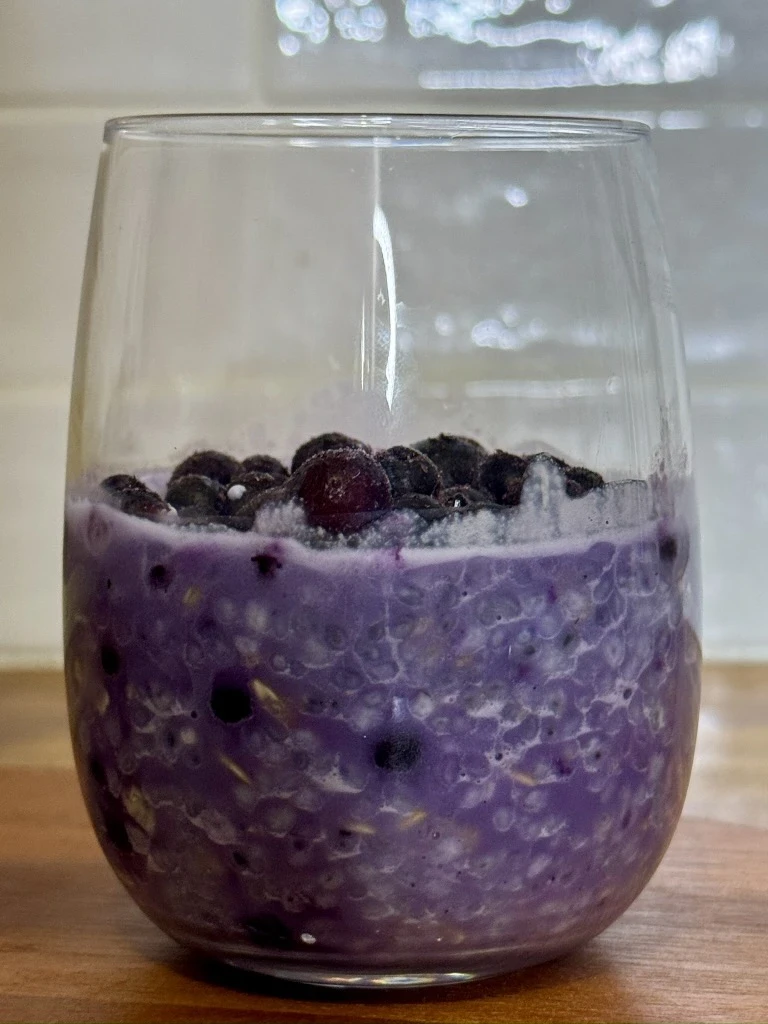 Blueberry chia pudding overnight oats with bright blue blueberries and basil seeds