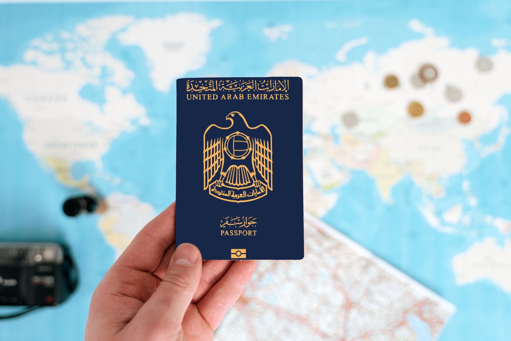A passport with a world map behind