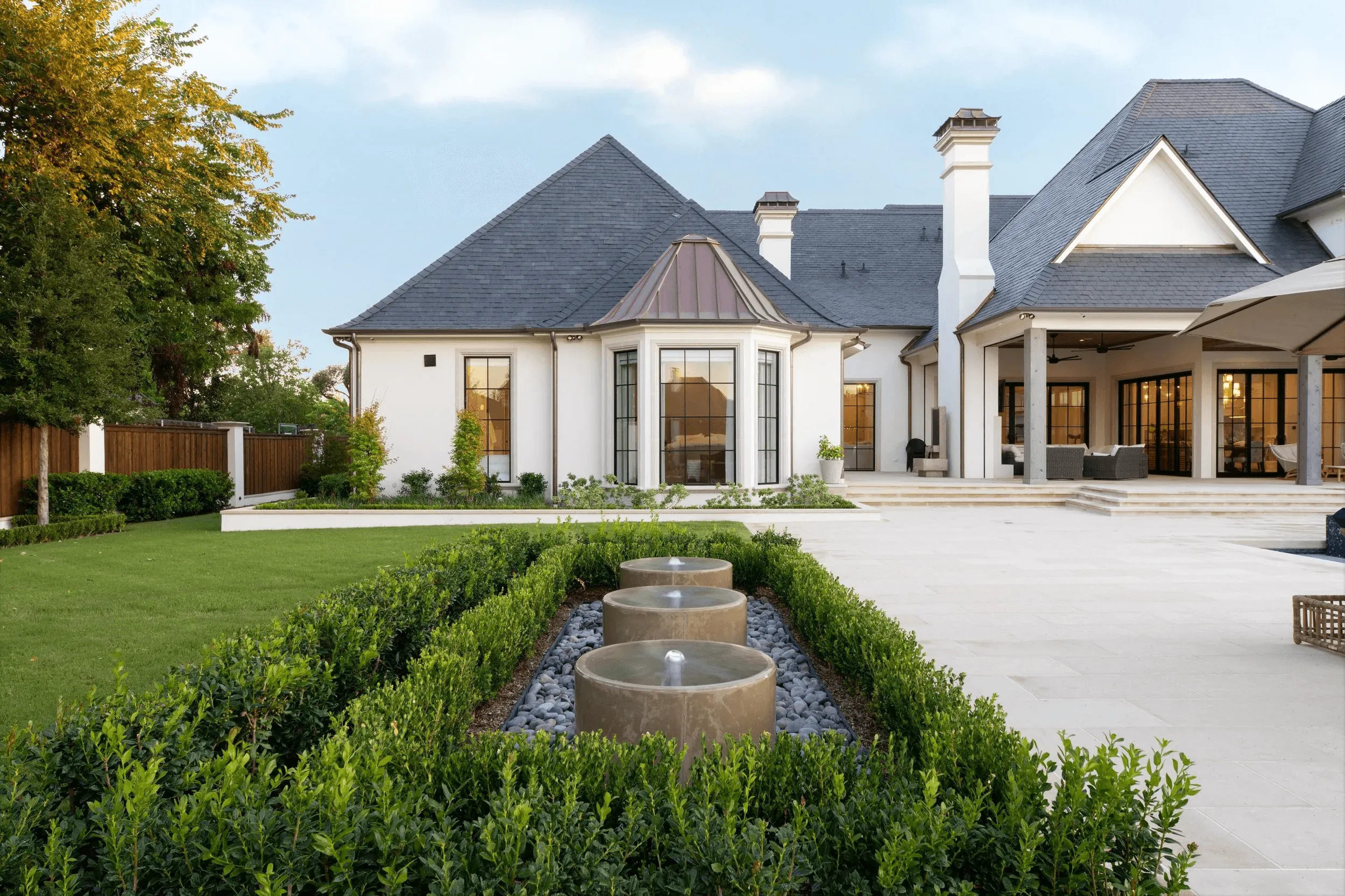 Backyard formal garden with water fountains for luxury outdoor living design in Preston Hollow Dallas