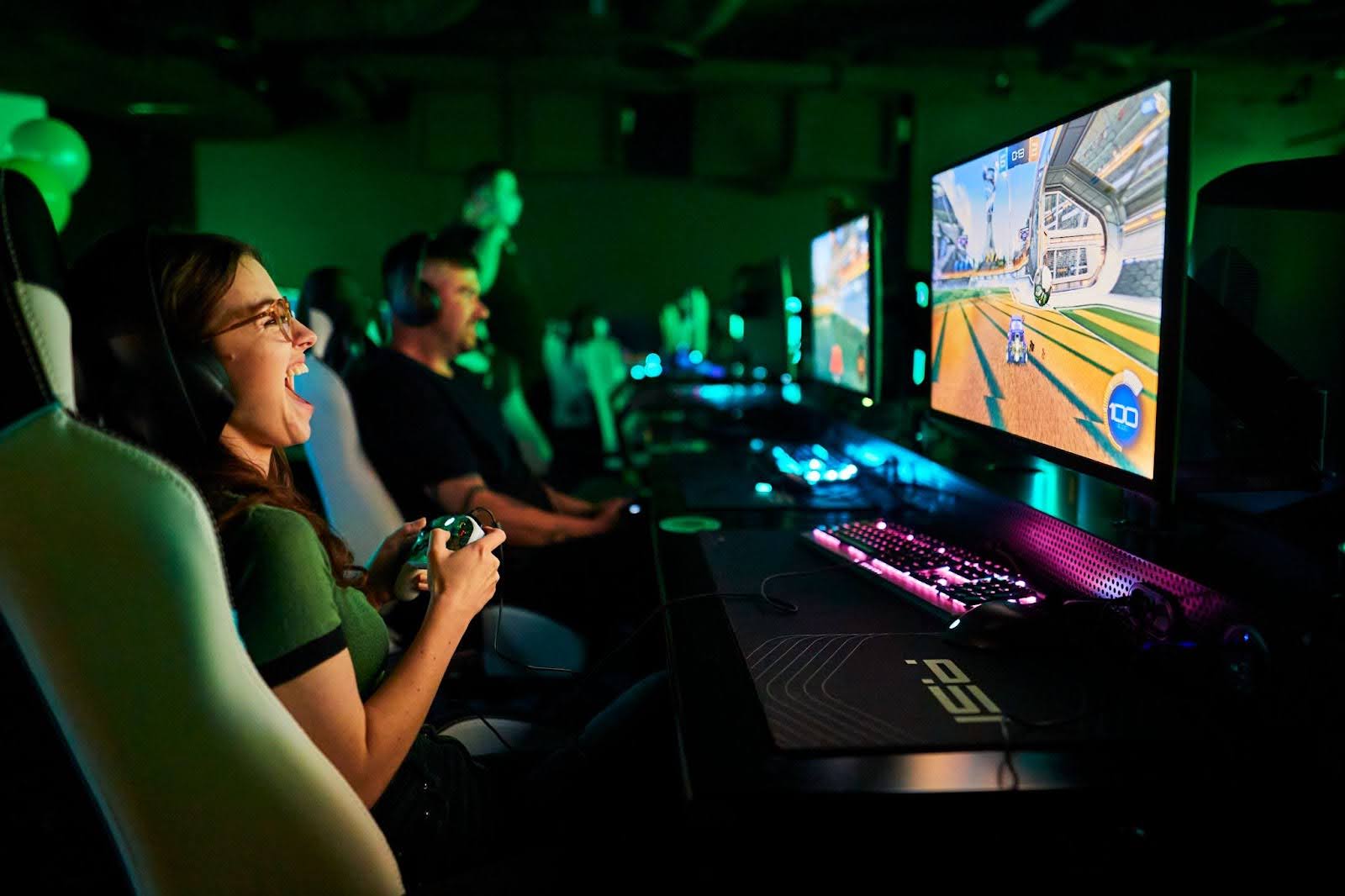 Groups of people playing on the computers in the Arena at Fortress