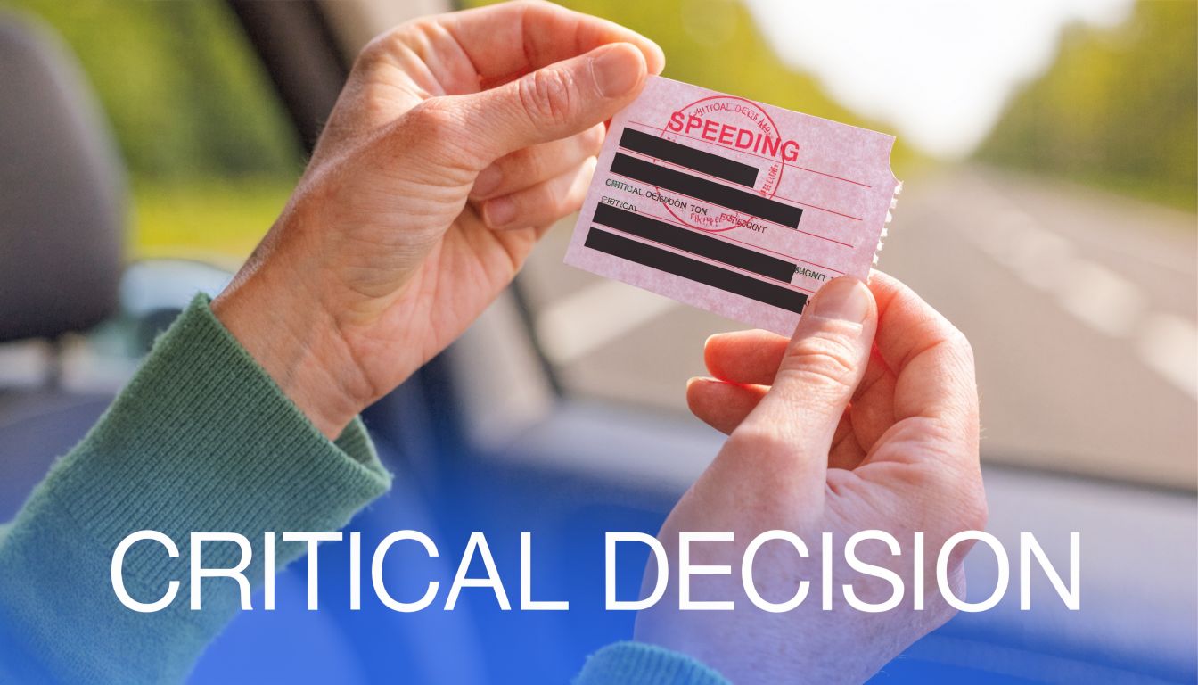 A person holding a physical speeding ticket card while driving, illustrating a critical decision-making process.