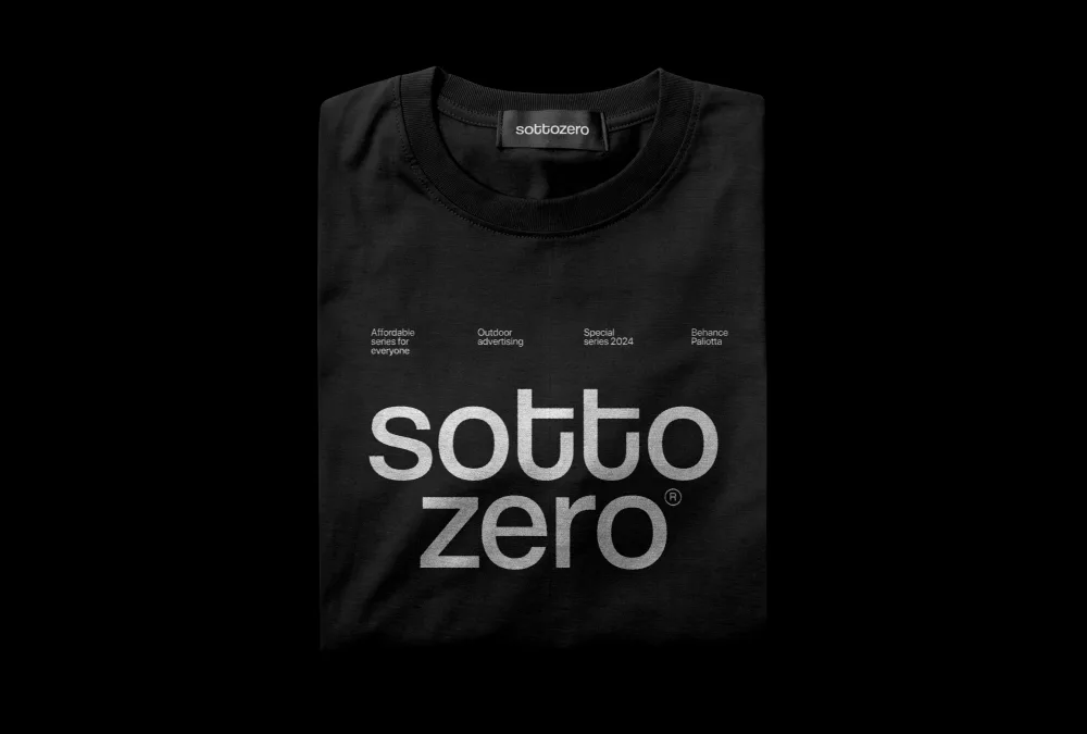 Folded red t-shirt mockup with a bold design printed in white. The shirt features a minimalistic layout, displayed against a black background to emphasize the vibrant color.
