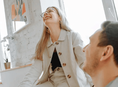 A close-up of hands performing a relaxing massage, with warm golden light illuminating the skin. The scene evokes a sense of relaxation and well-being.