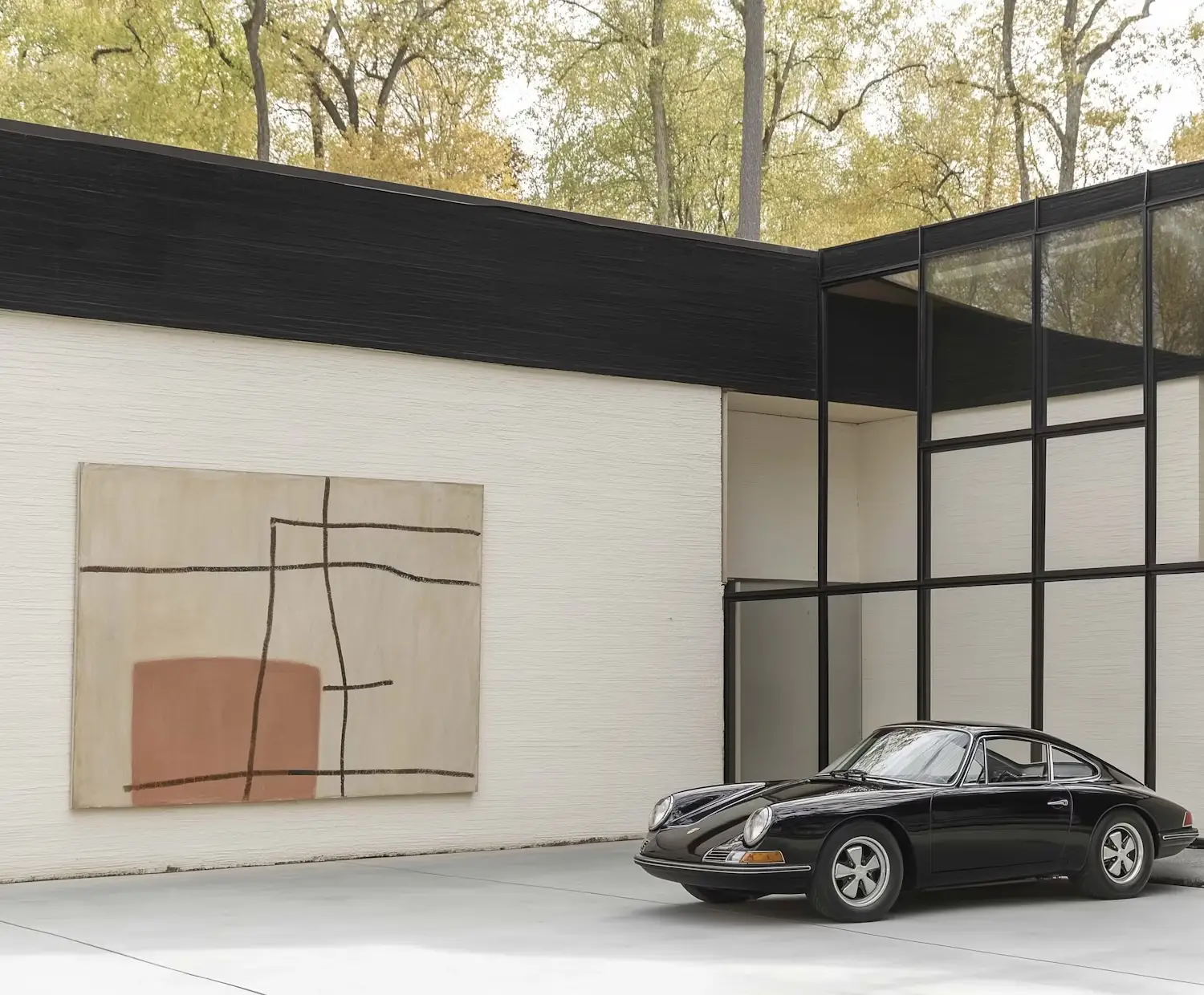 Black vintage sports car in modern carport with abstract art.