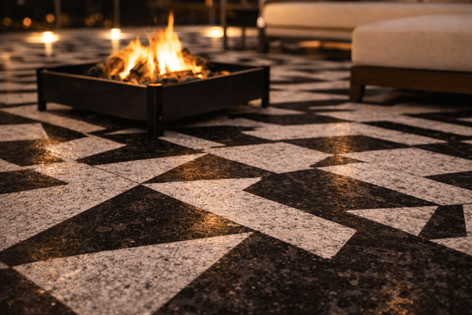 Geometric stone flooring design in outdoor seating area with firepit feature