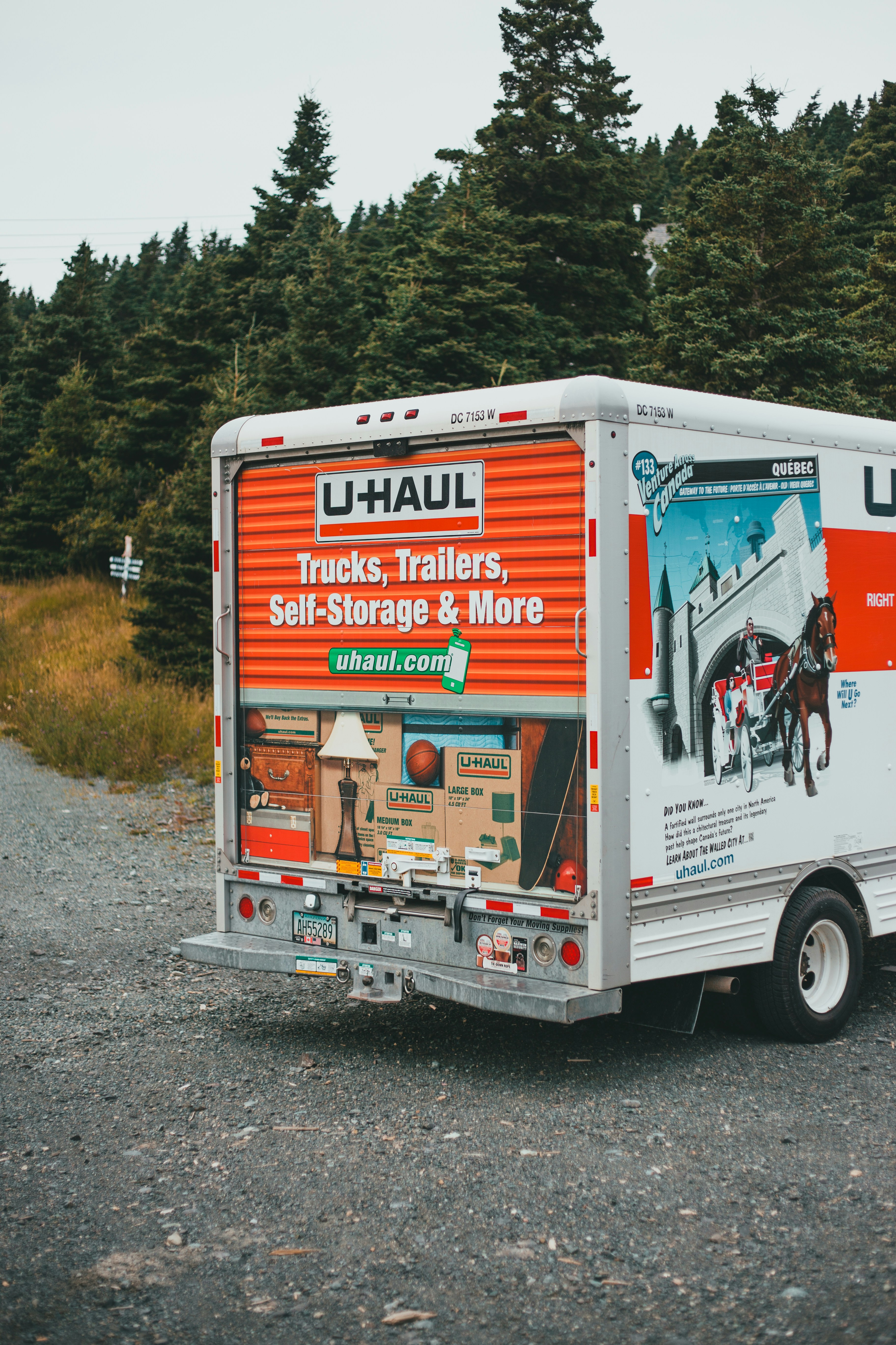 a moving truck parked on the side of a road