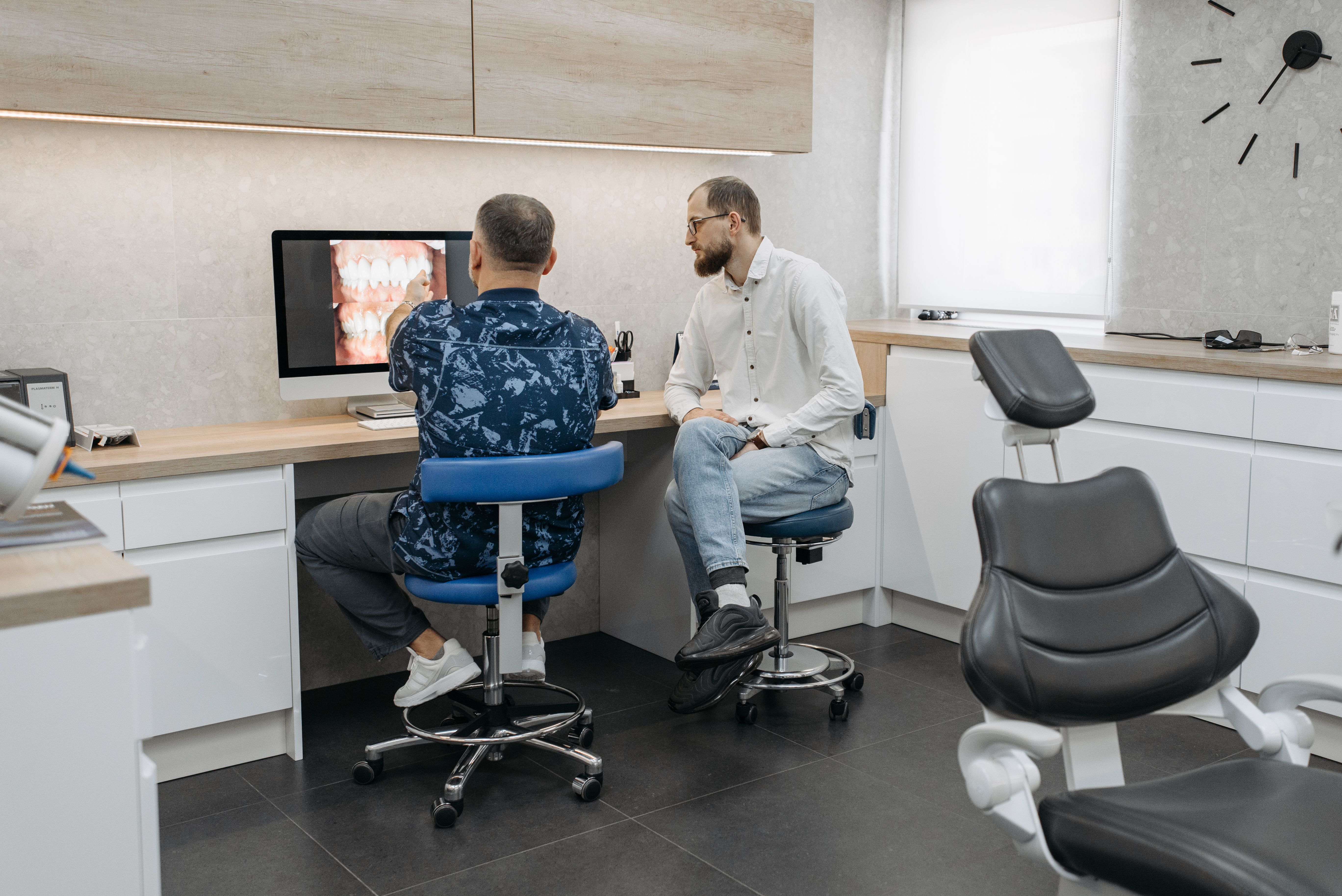 Dentist discussing oral health and treatment options with a patient