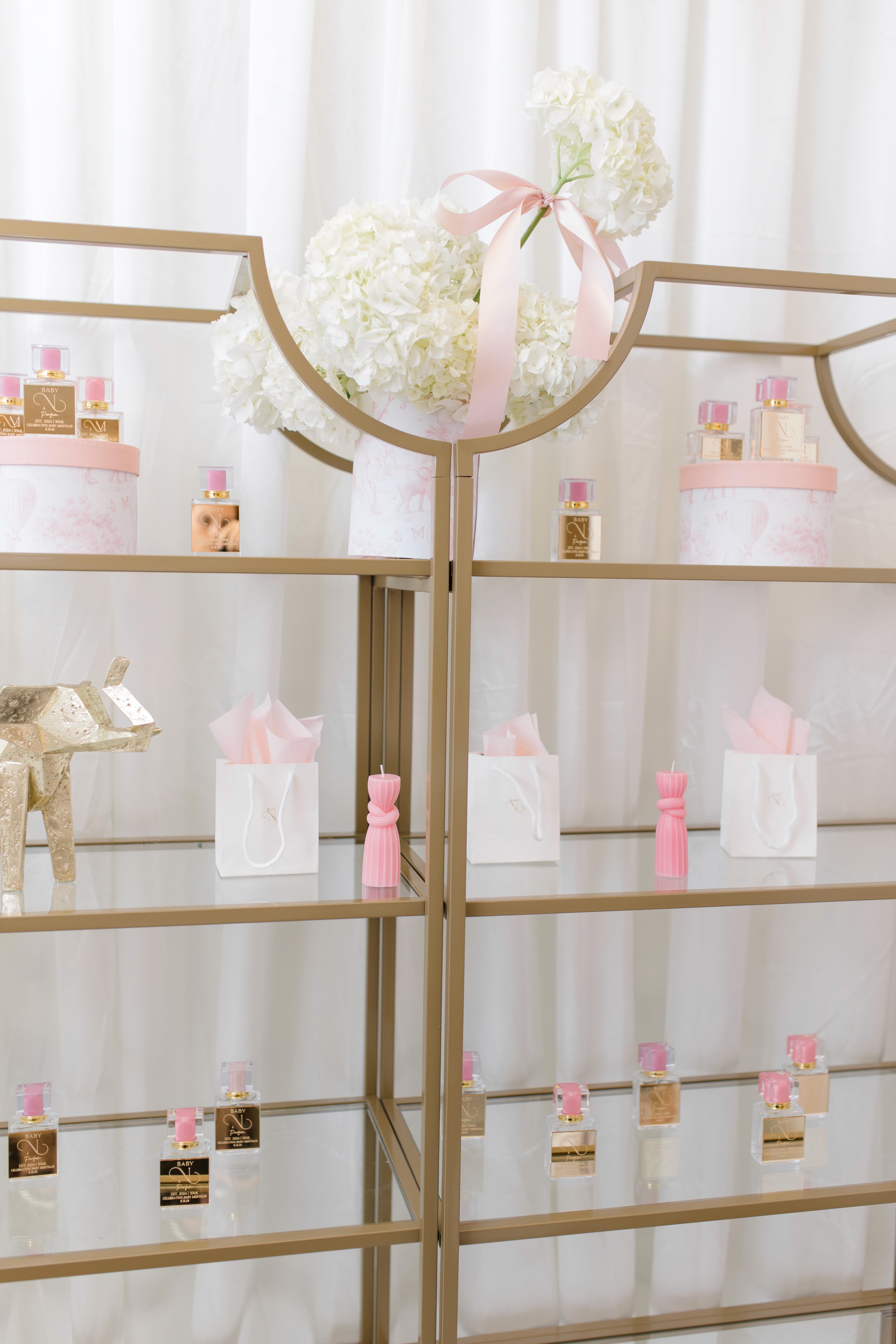 a hand holding a bottle of black perfume