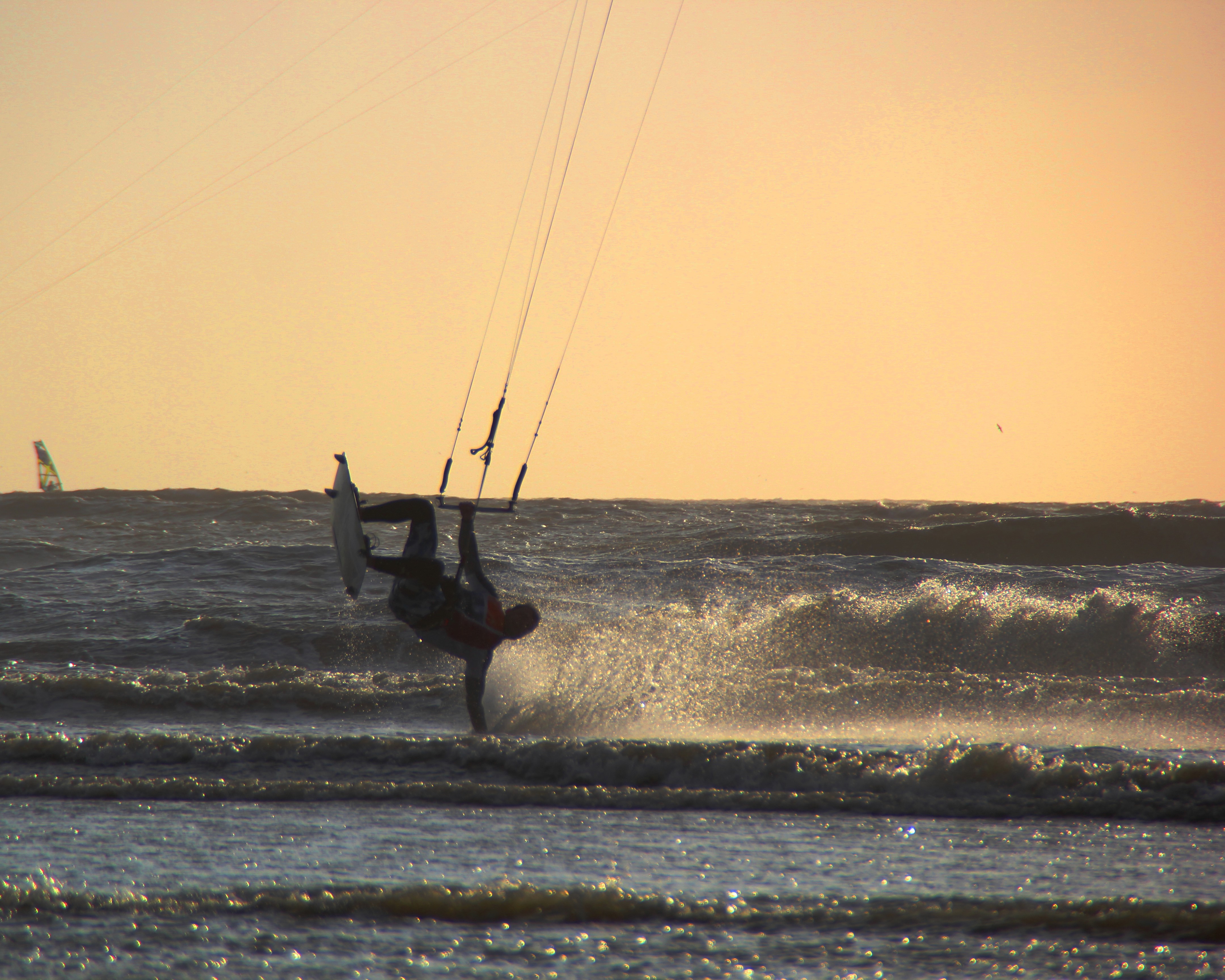 Tobi Deckert, sports model, kitesurf handplant at sunset