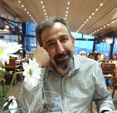 woman in black crew neck t-shirt wearing brown framed eyeglasses standing on rocky shore during