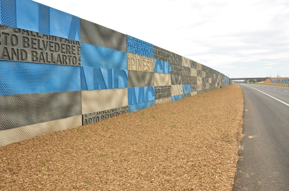 A recycled plastic noisewall alongside a highway