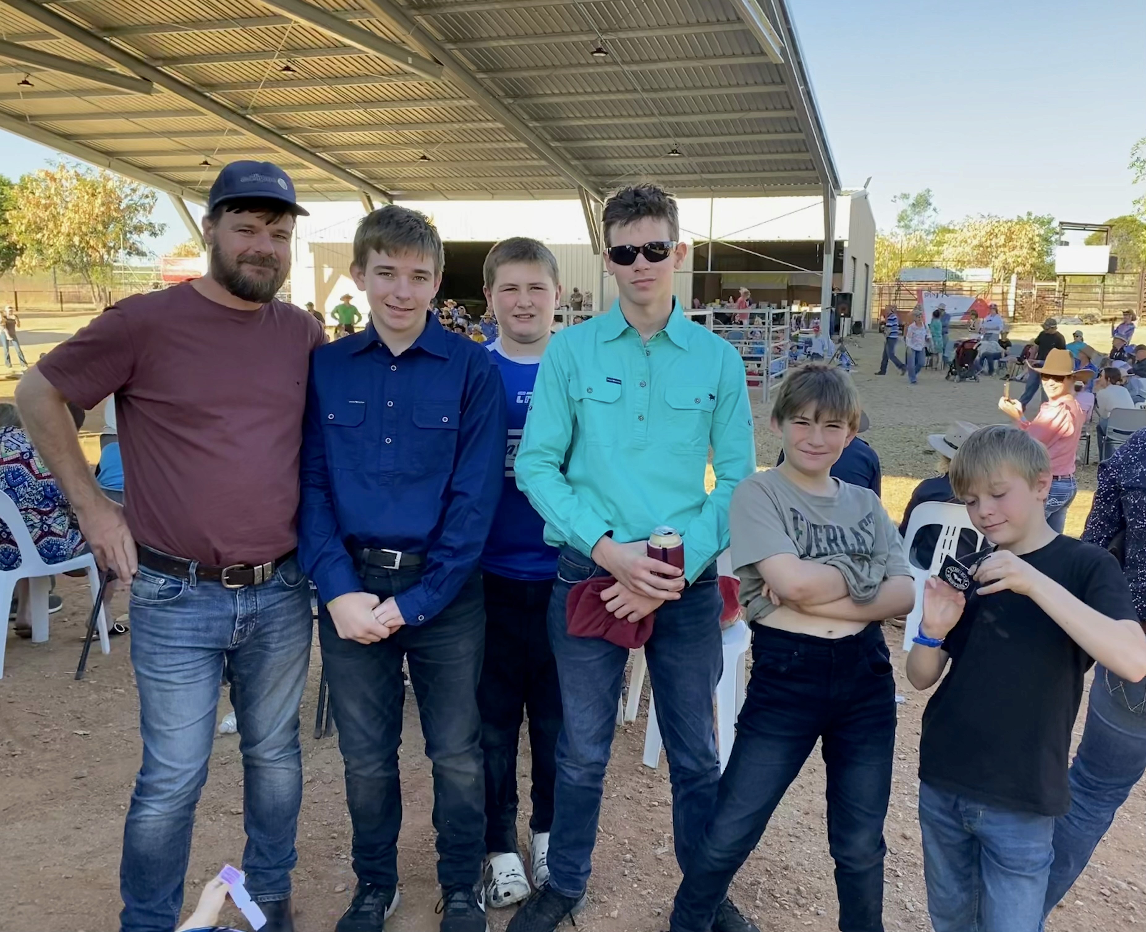 Ross with his sons at a cattle yard sale, engaging with clients and demonstrating agribusiness finance support