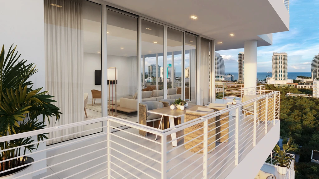 Modern apartment balcony with outdoor dining area, glass doors leading to a living room, city buildings, and greenery visible in the background.