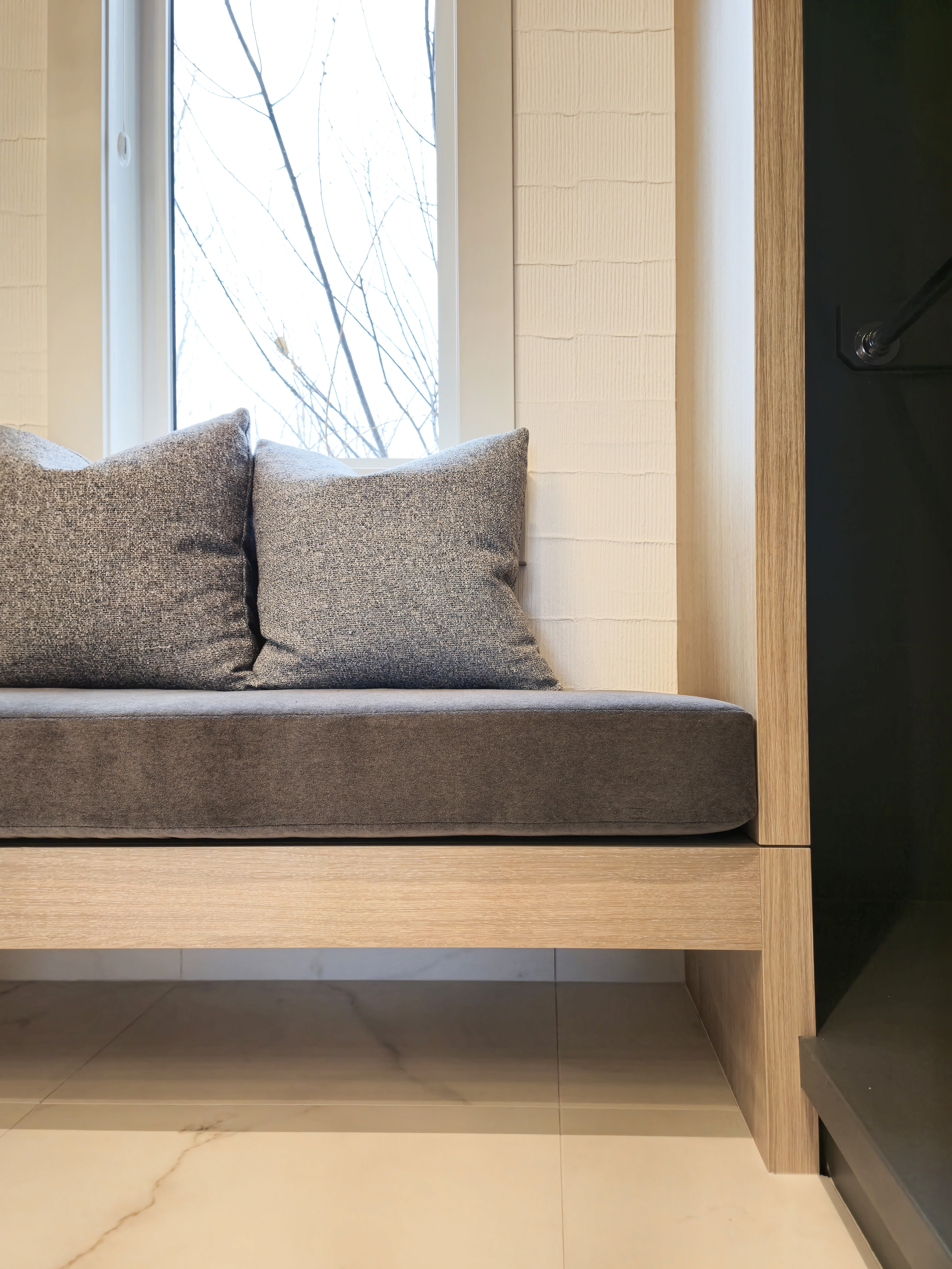 Image of bench with light grey cushions.