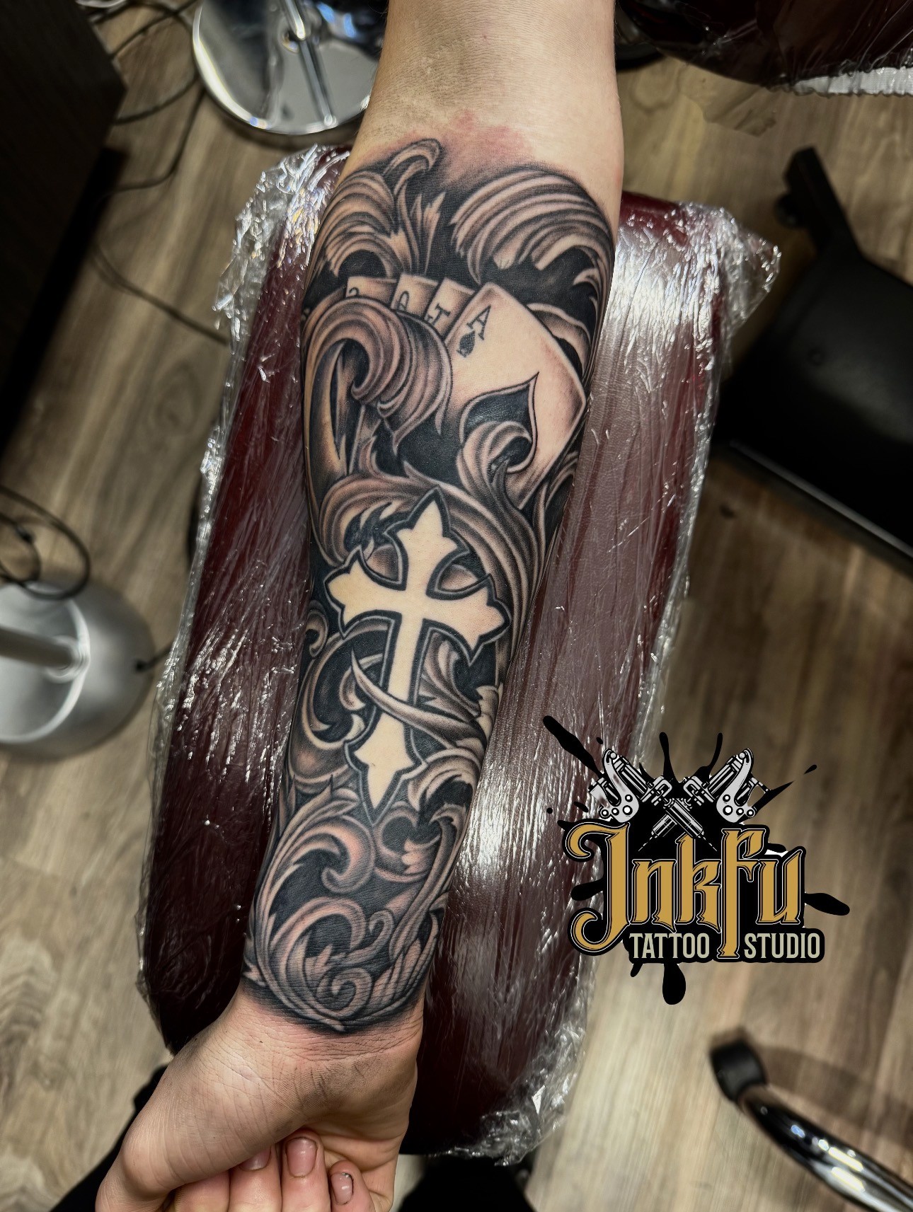 Cards and Cross Sleeve: black and grey tattoo on the forearm, by Meer Rich