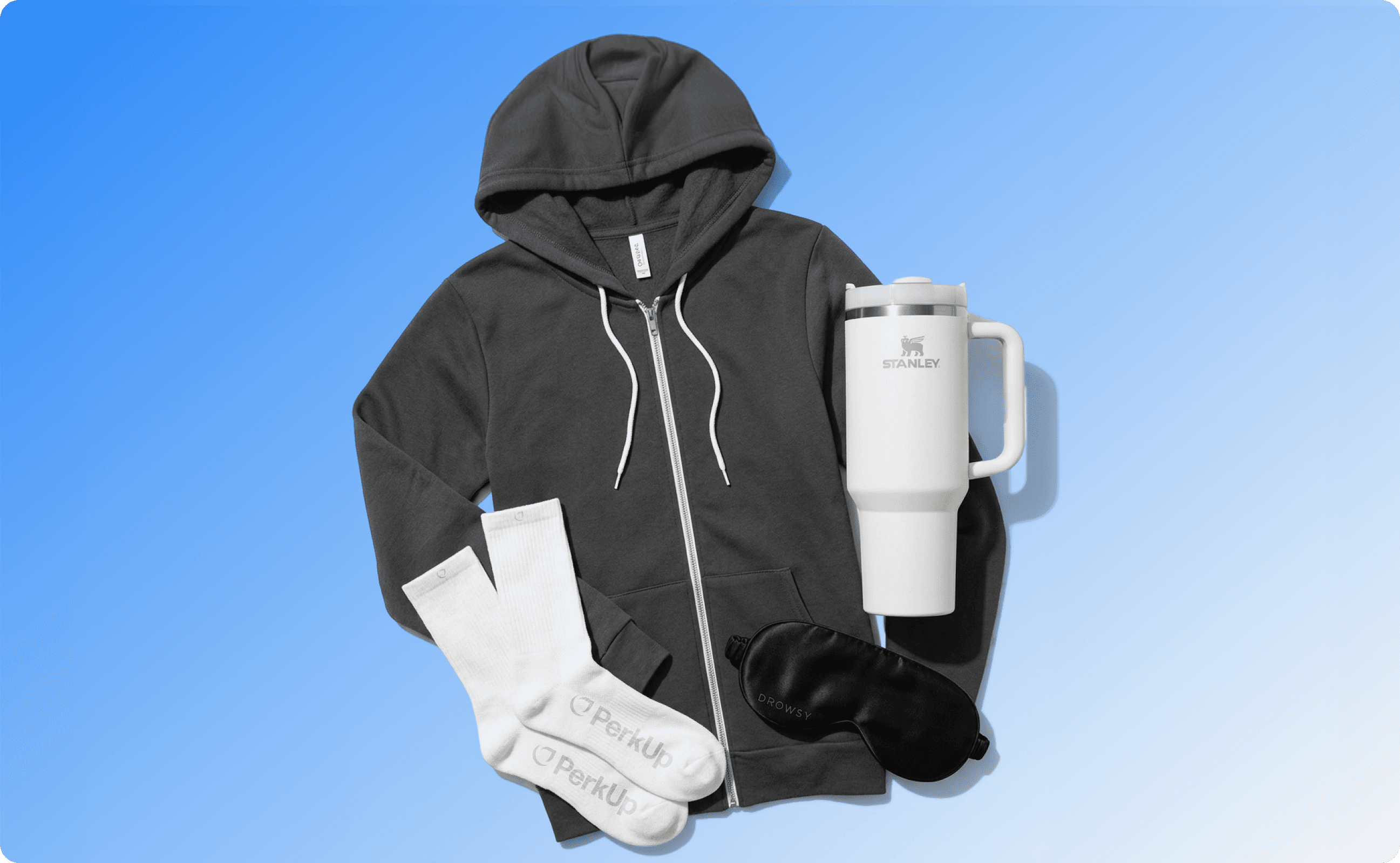 A hoodie, socks, and a Stanley Quencher tumbler.