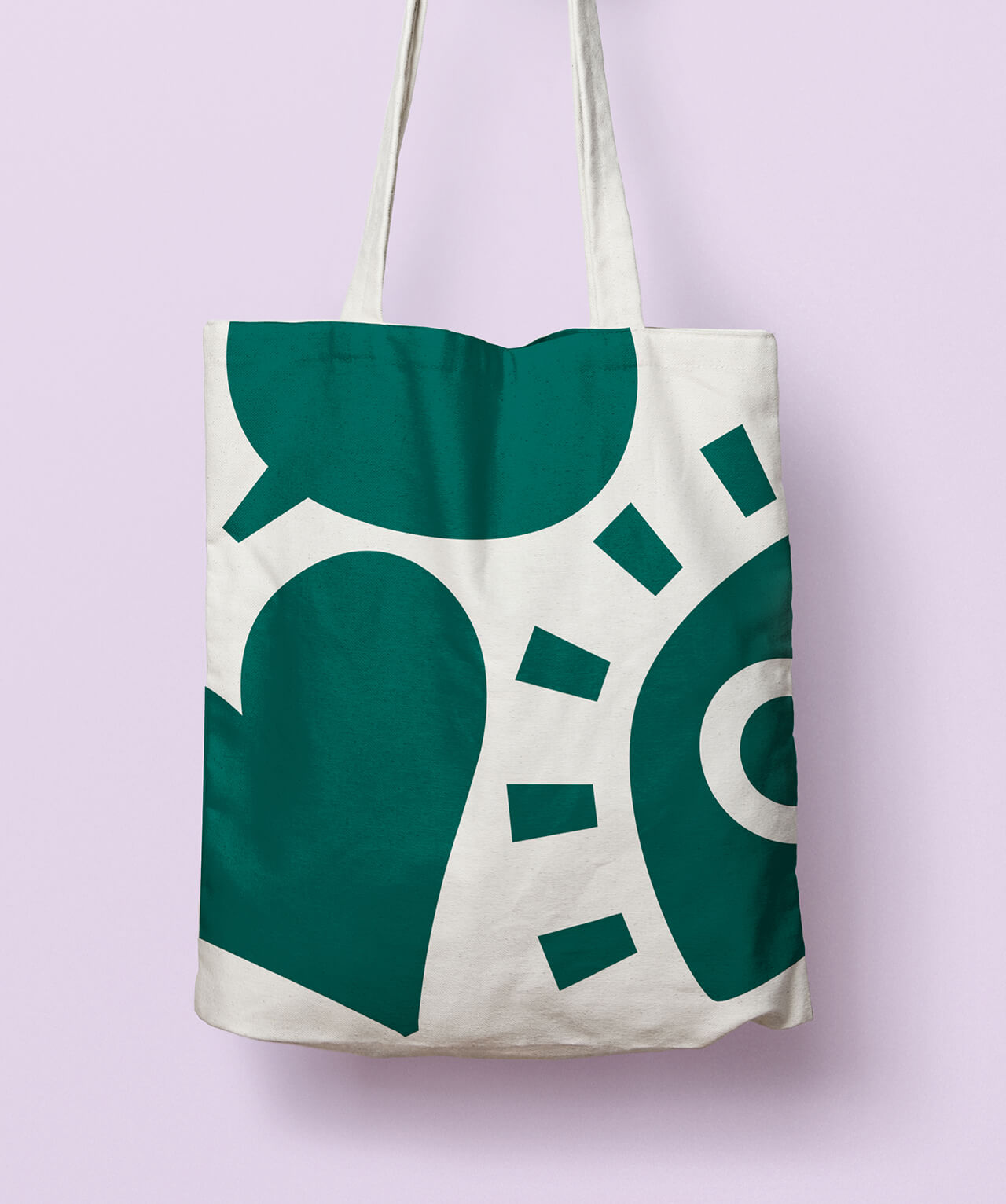 A branded tote bag featuring large, playful icons of a speech bubble, a heart, and an eye.