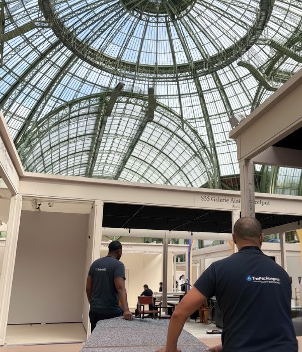 ThePackengers staff managing an on-site installation under a glass-domed gallery ceiling, representing expert logistics for art fairs and luxury exhibitions.