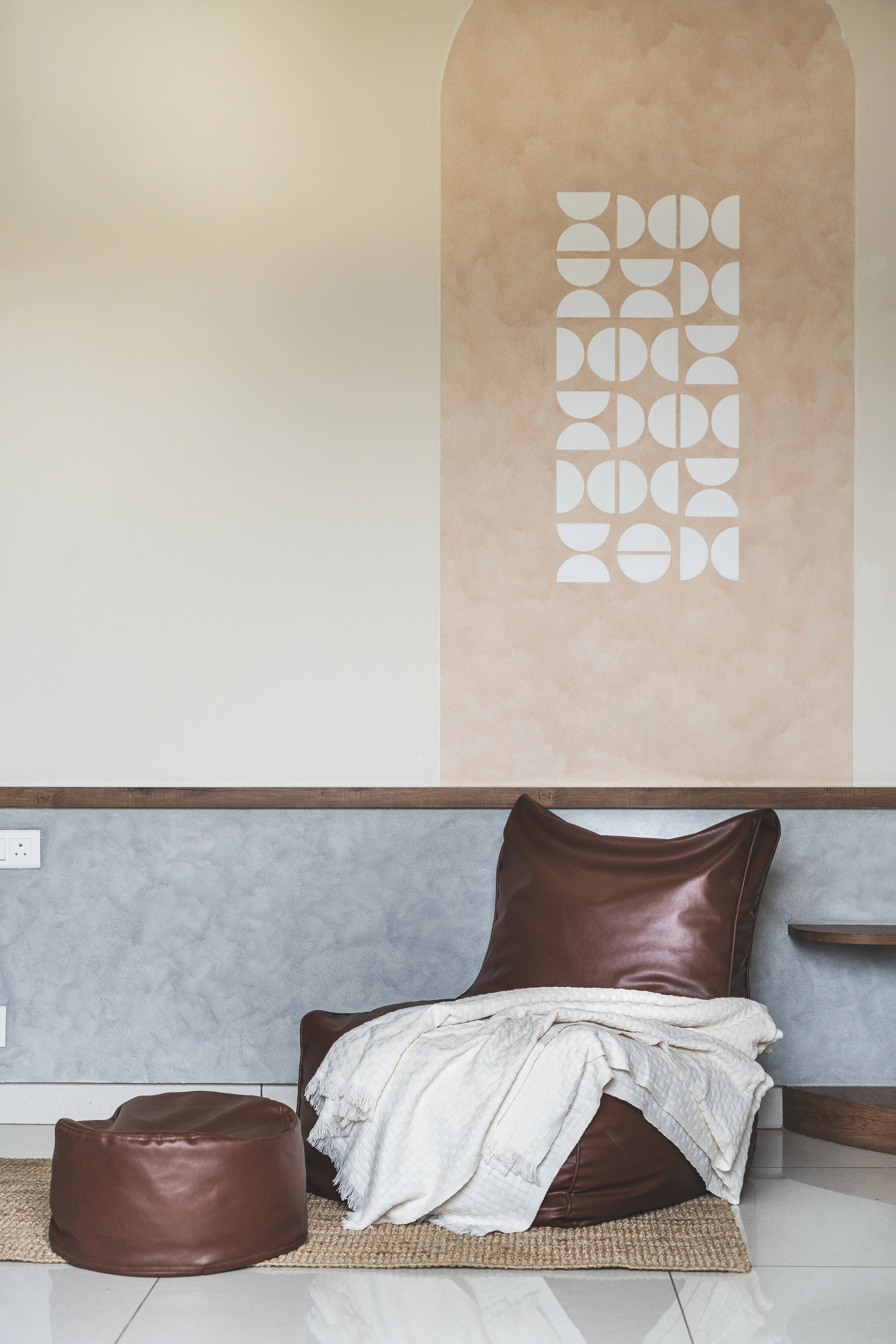 A modern study room featuring a bean bag chair and a television, designed with curves for a minimal aesthetic in South Indian homes.