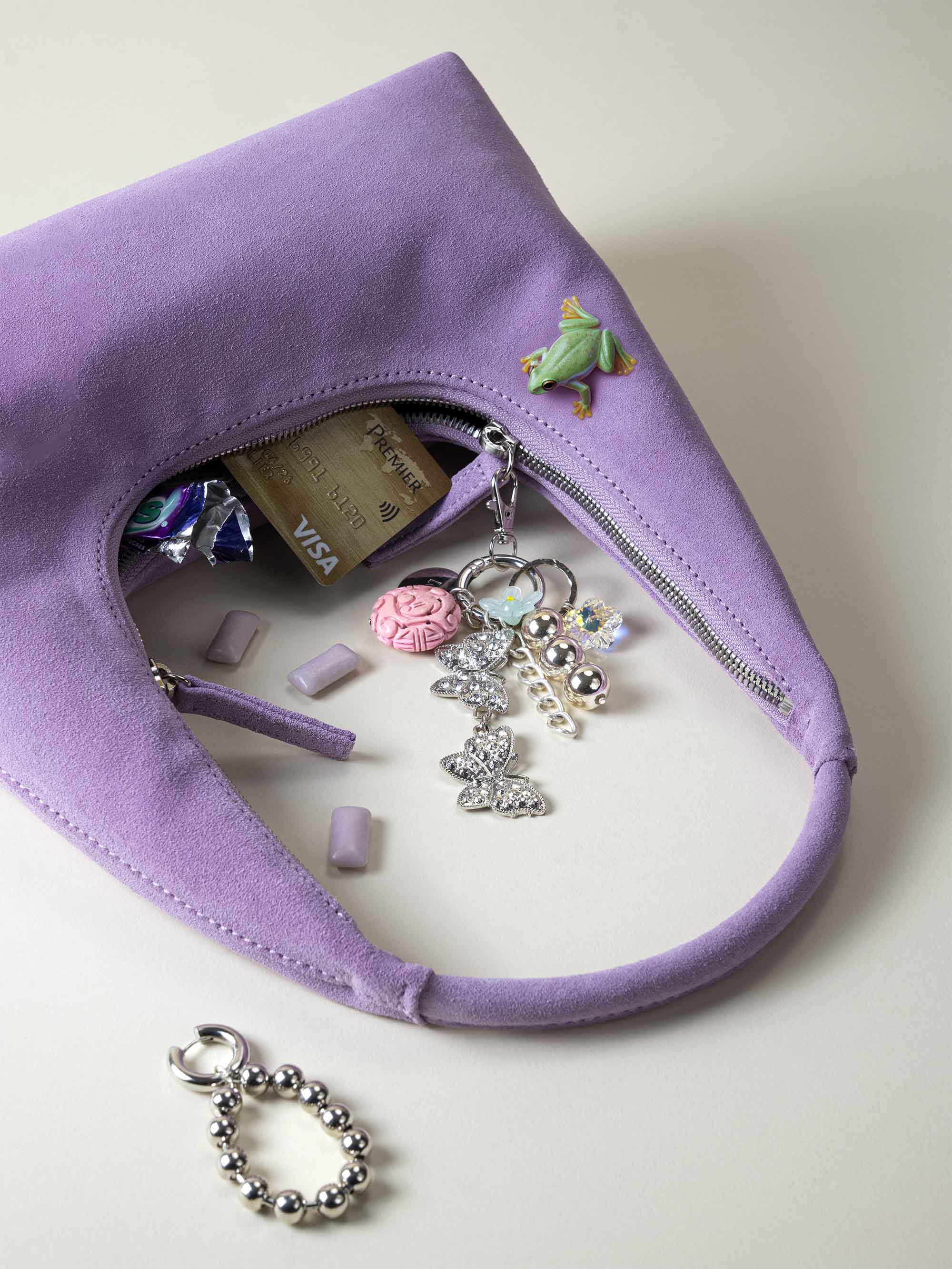 photographie éditoriale de bijoux de sac haute fantaisie sur sac à main violet