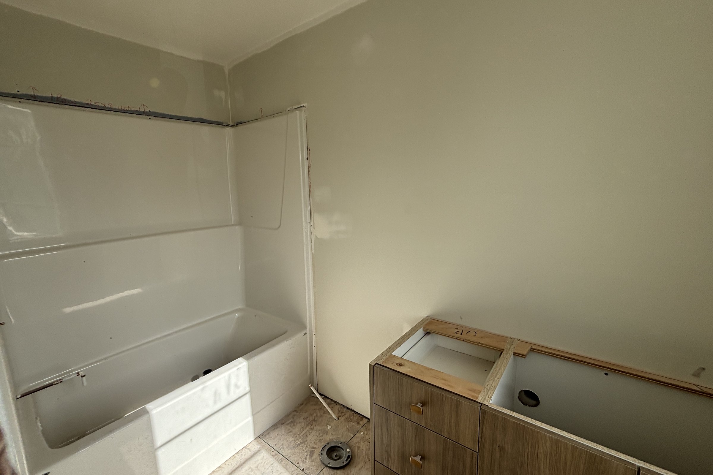 Heartland bathroom during construction: tub surround and vanity box before finishing