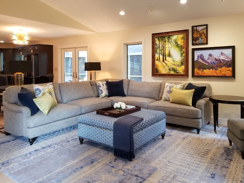 Image of KHD Homes interior design featuring a cozy living room with sectional sofa and ottoman layout design.