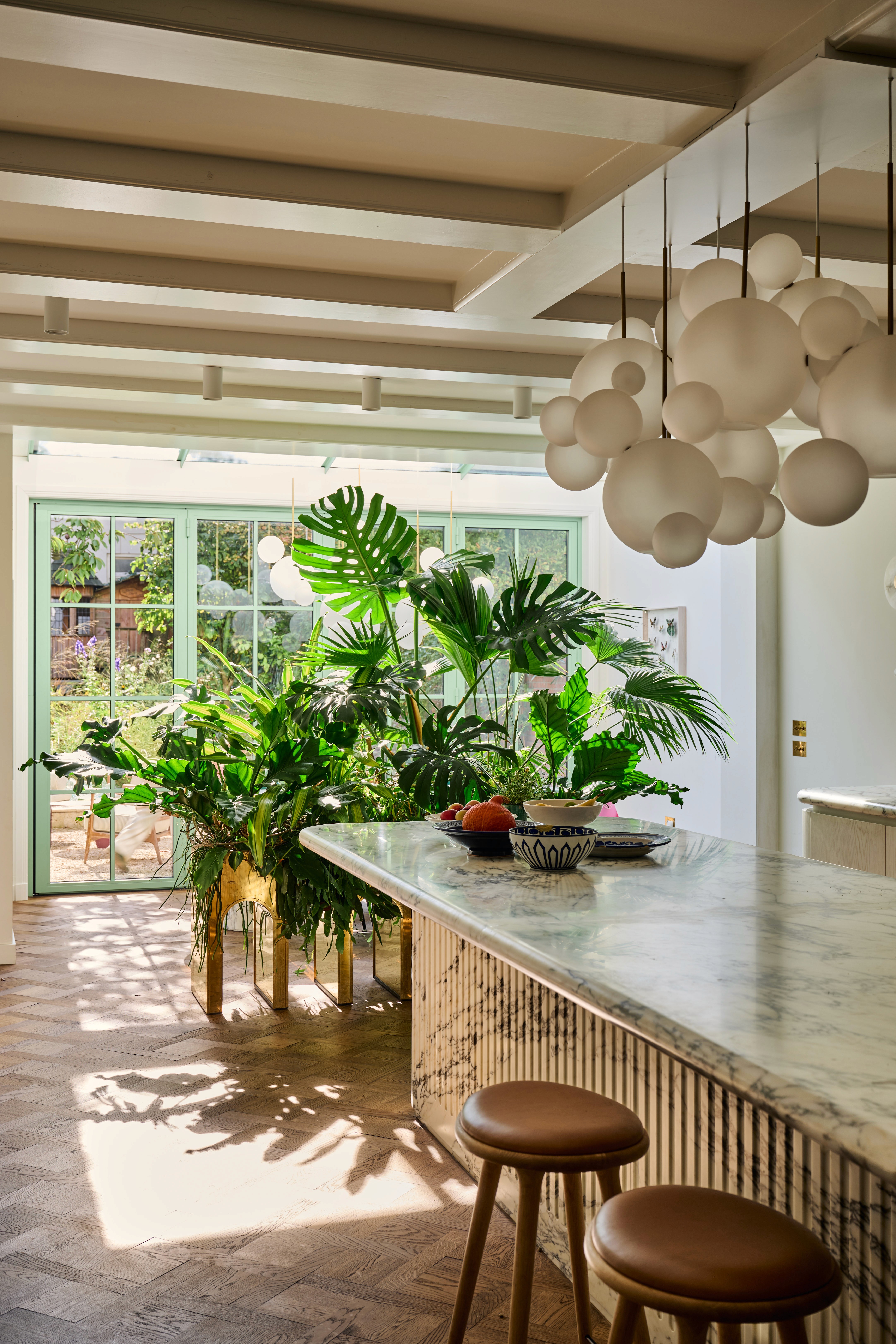 Modern interior entrance with floor-to-ceiling glass walls and warm timber cladding overlooking landscape