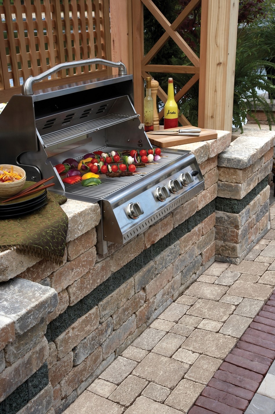 Stone grill station with dark stacked-stone base and granite countertop