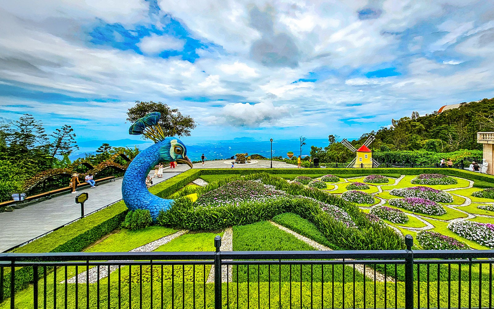 Garden with peacock sculpture and windmill at Sun World Ba Na Hills.