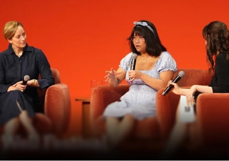 Three woman speaking with one another