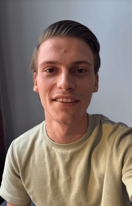 man standing beside wall