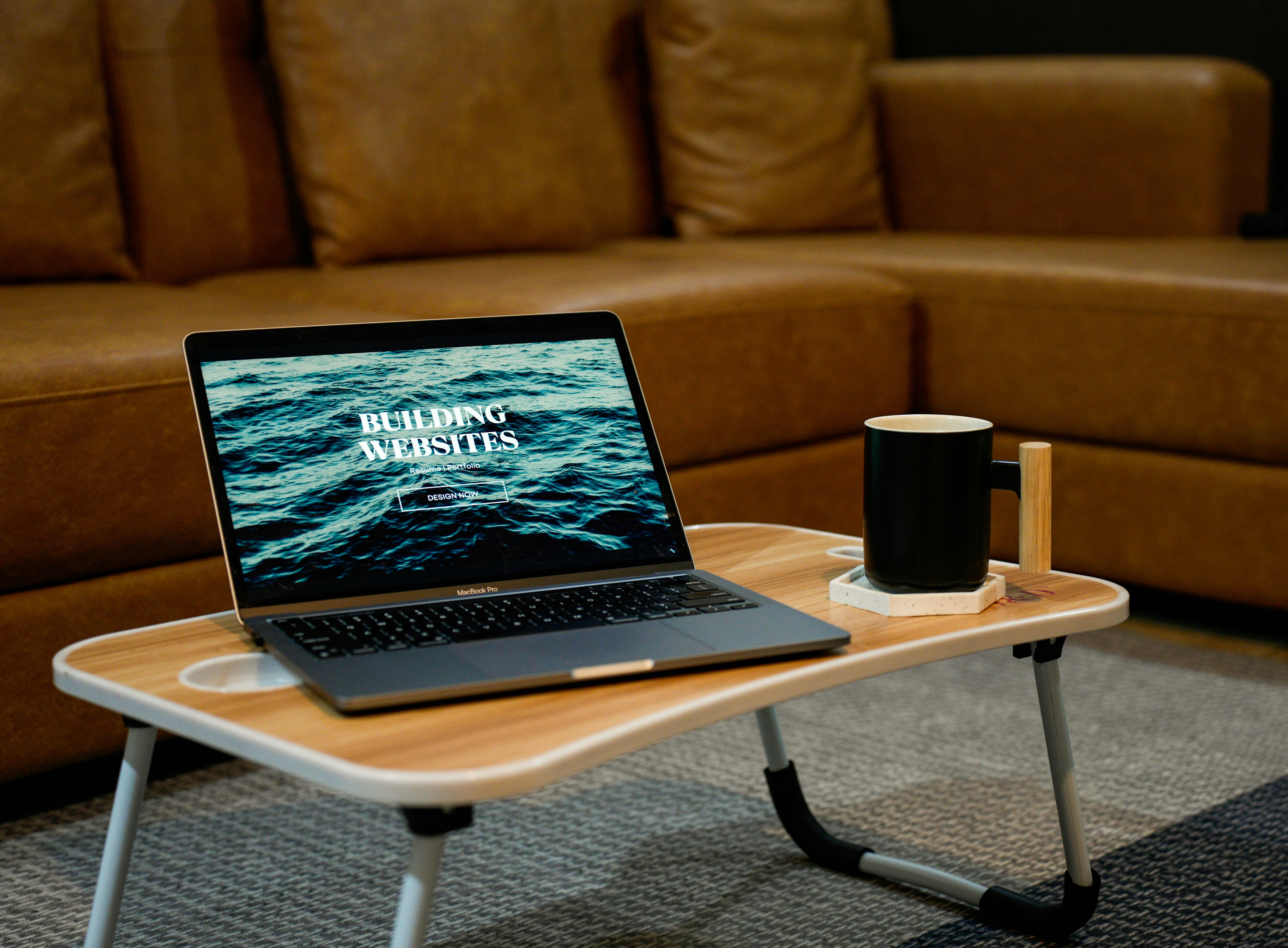 a laptop computer sitting on top of a wooden table