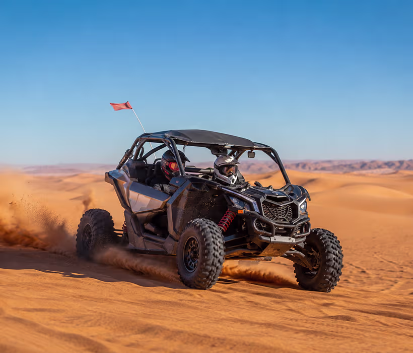 Dune buggy driving through Sahara sand dunes