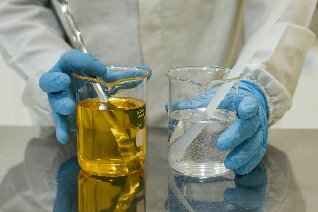 person holding black glass bottle