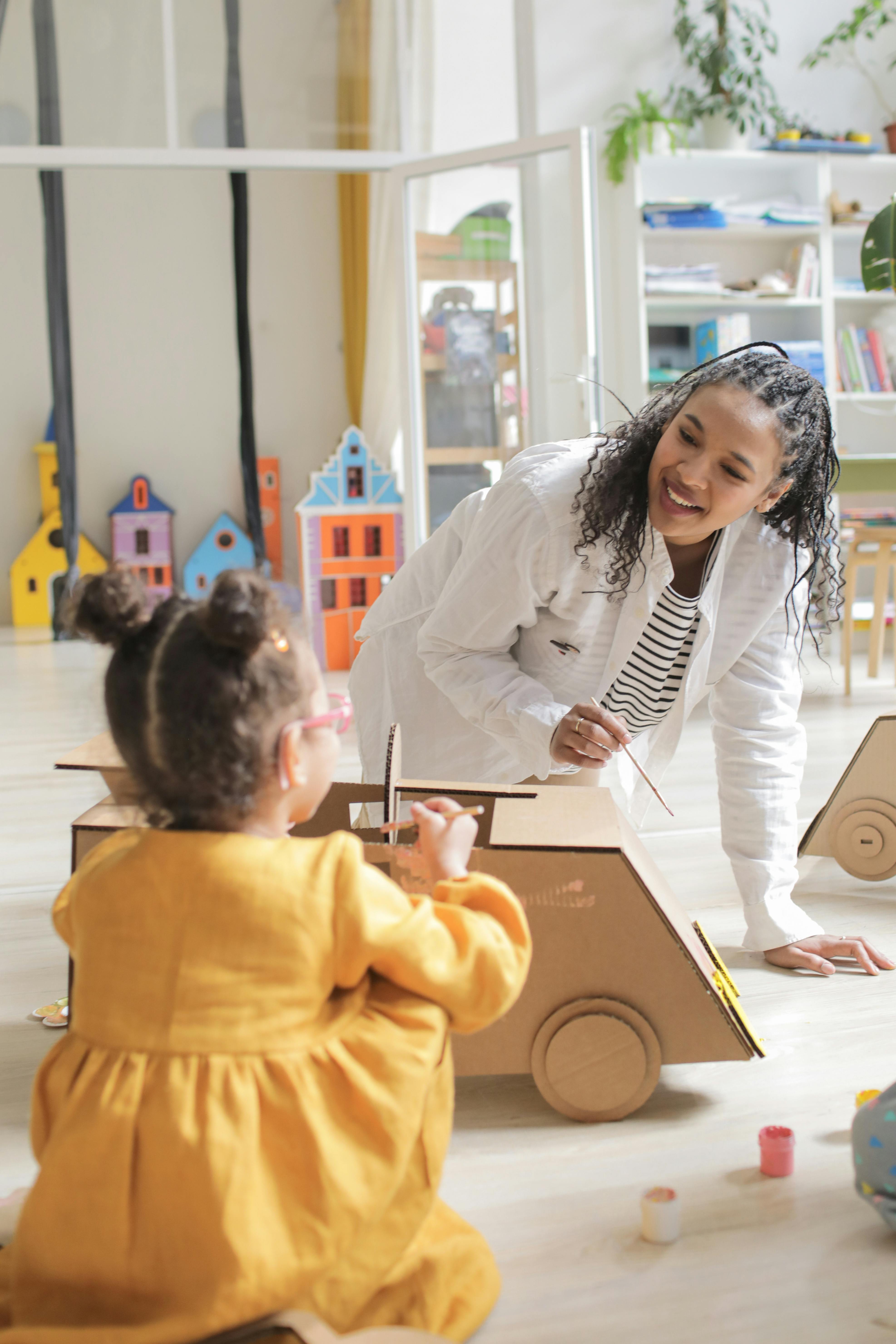 Psychologist engaging with a young child in a supportive play-based therapy environment