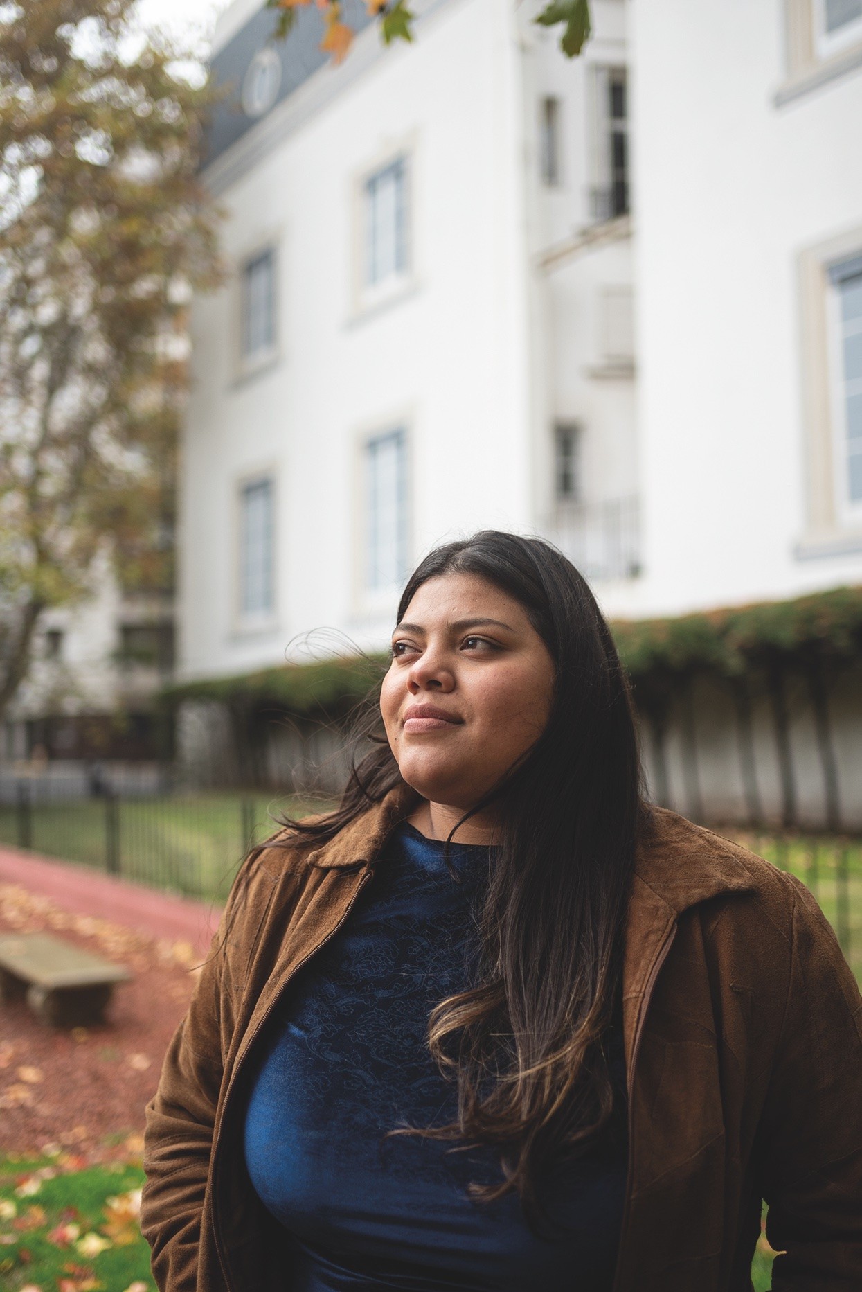 a couple of people standing next to a motorcycle