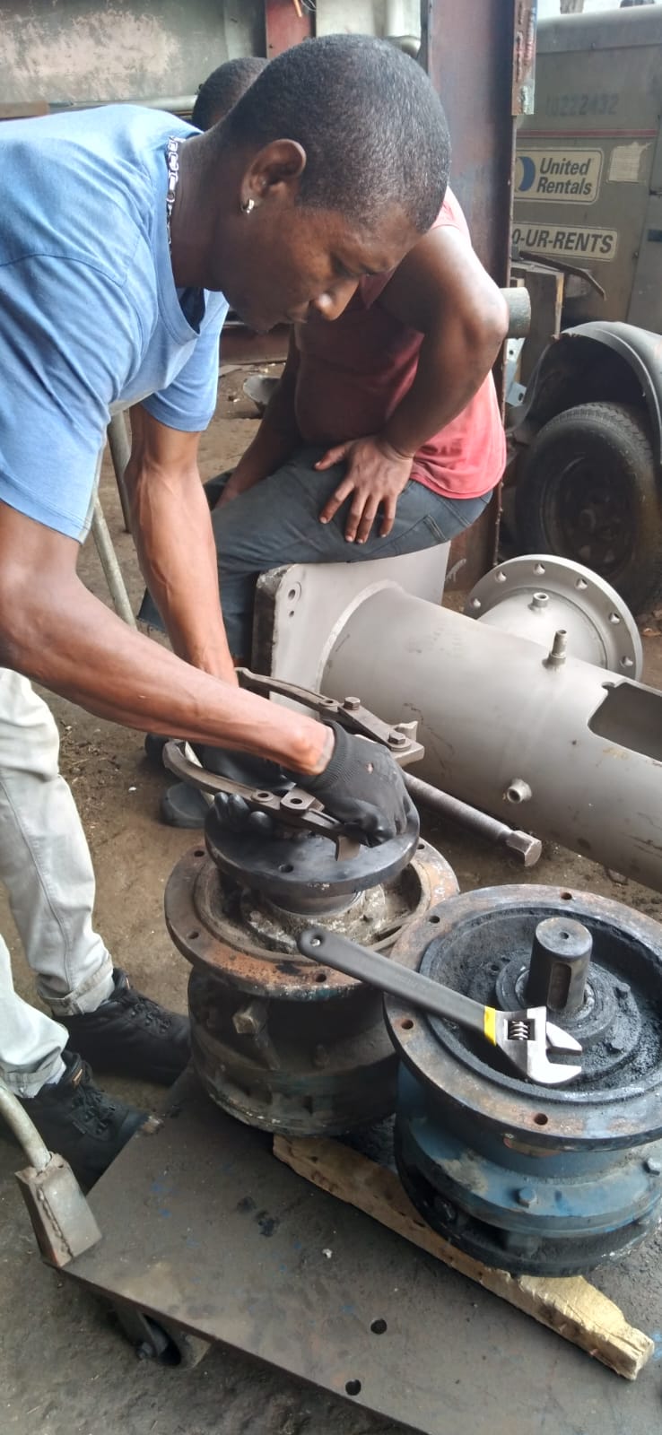 A smartphone with a mockup screen design rests on a textured rock surface. The mockup text reads "iPhone Mockup Free PSD 2024" in bold letters
