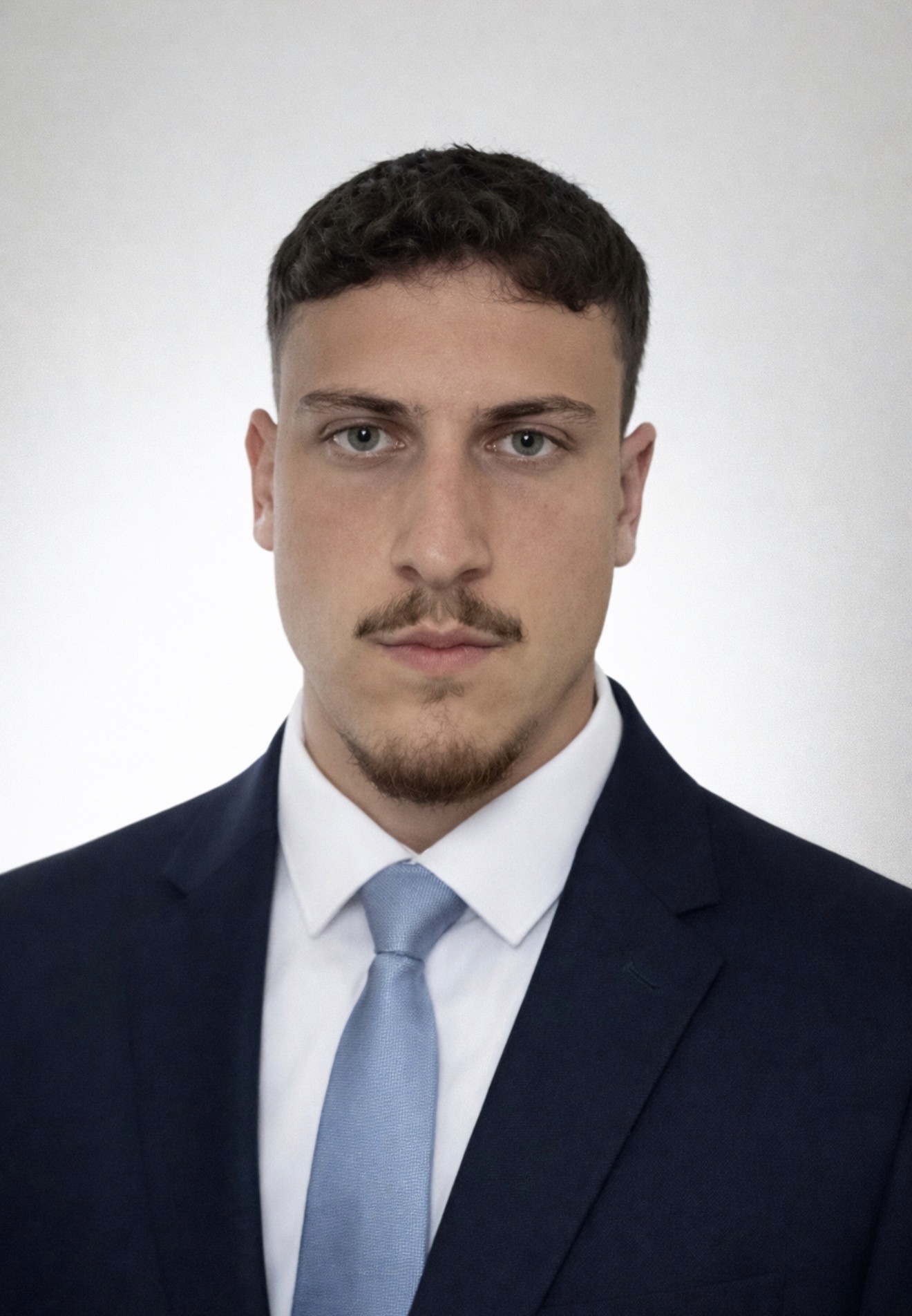 a man with dreadlocks standing in front of a building